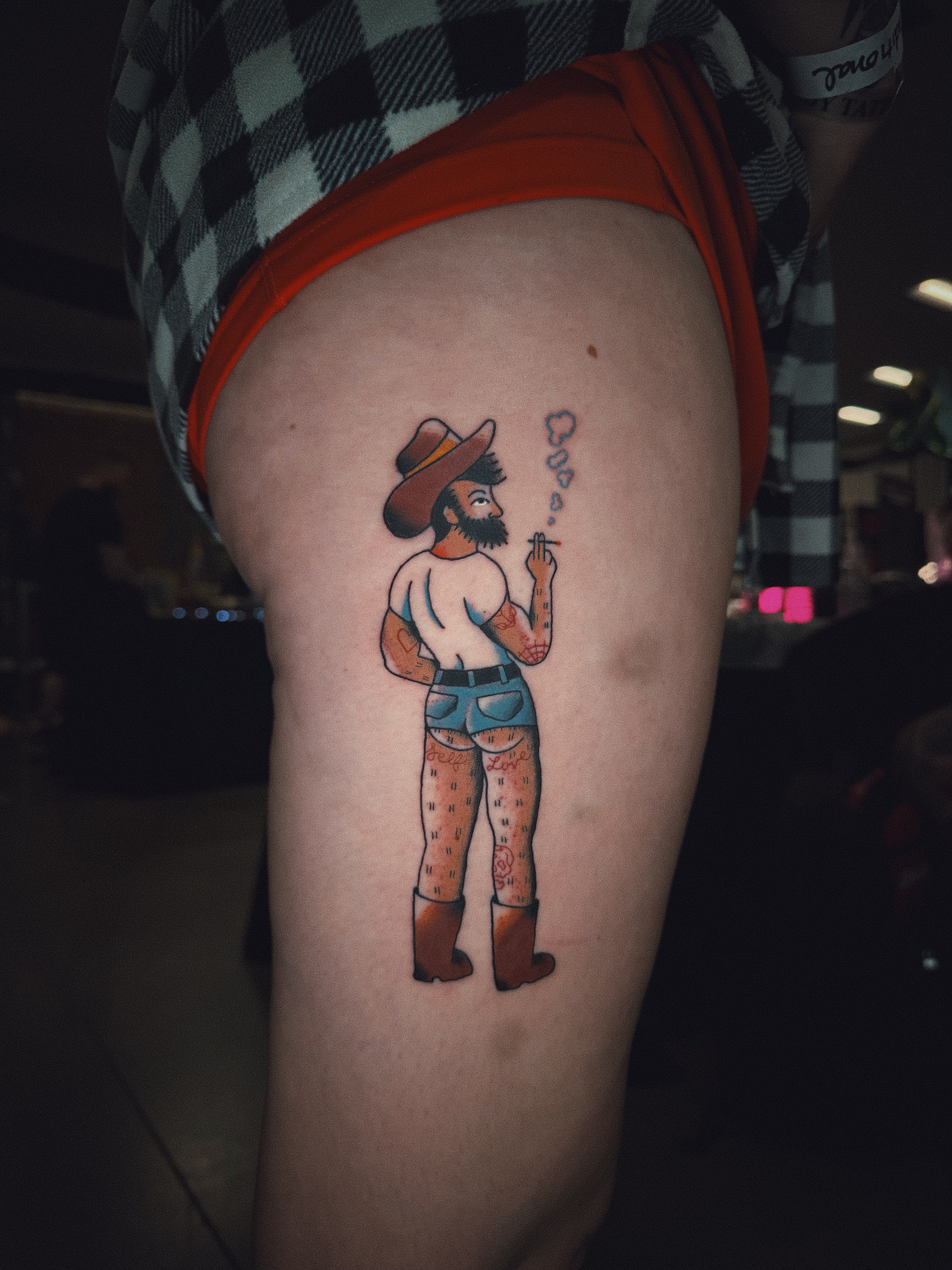 Cowboy smoking American traditional tattoo on the thigh by Dustie Pitstick