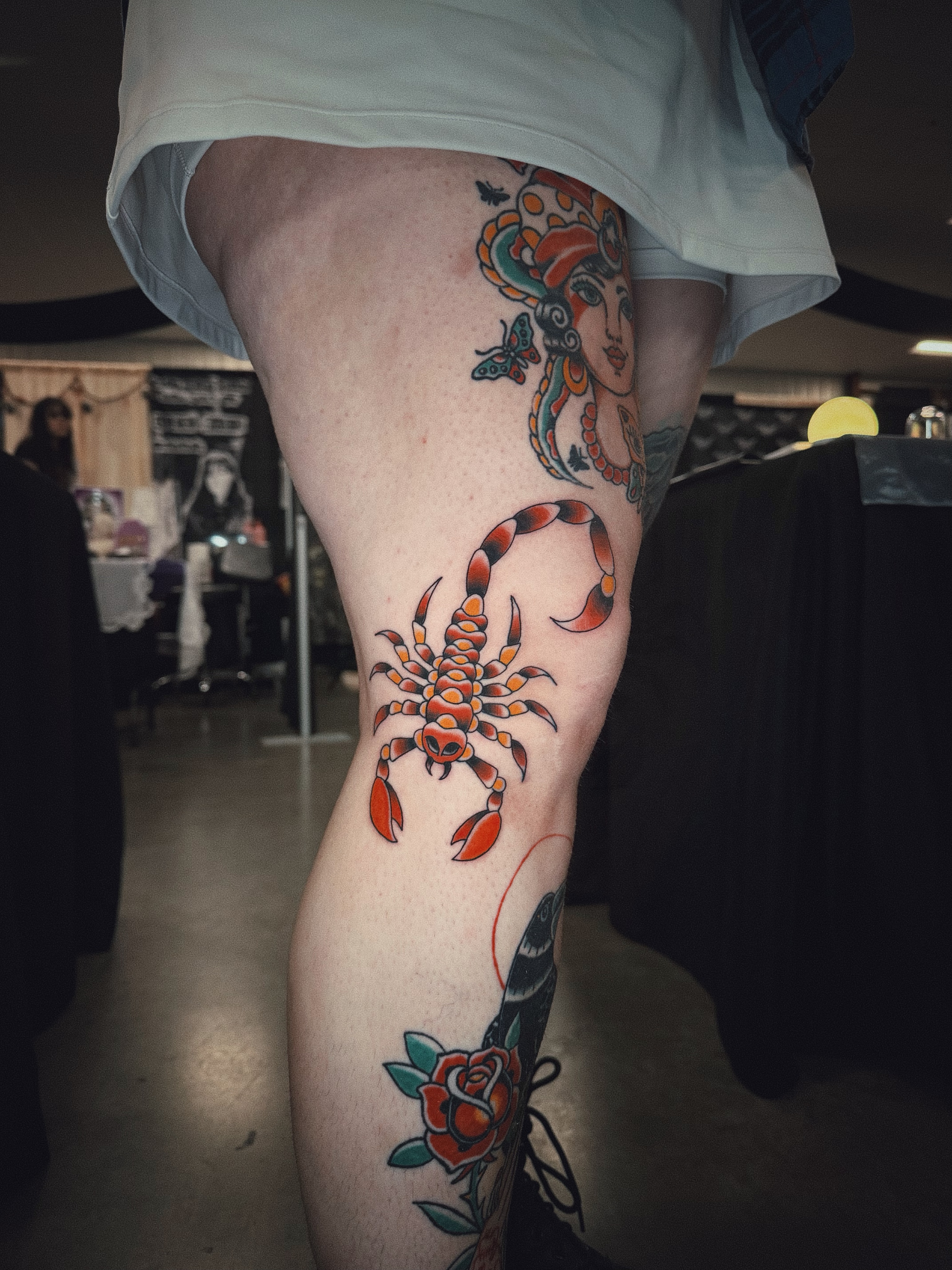Scorpion and woman American traditional tattoo on the thigh by Dustie Pitstick