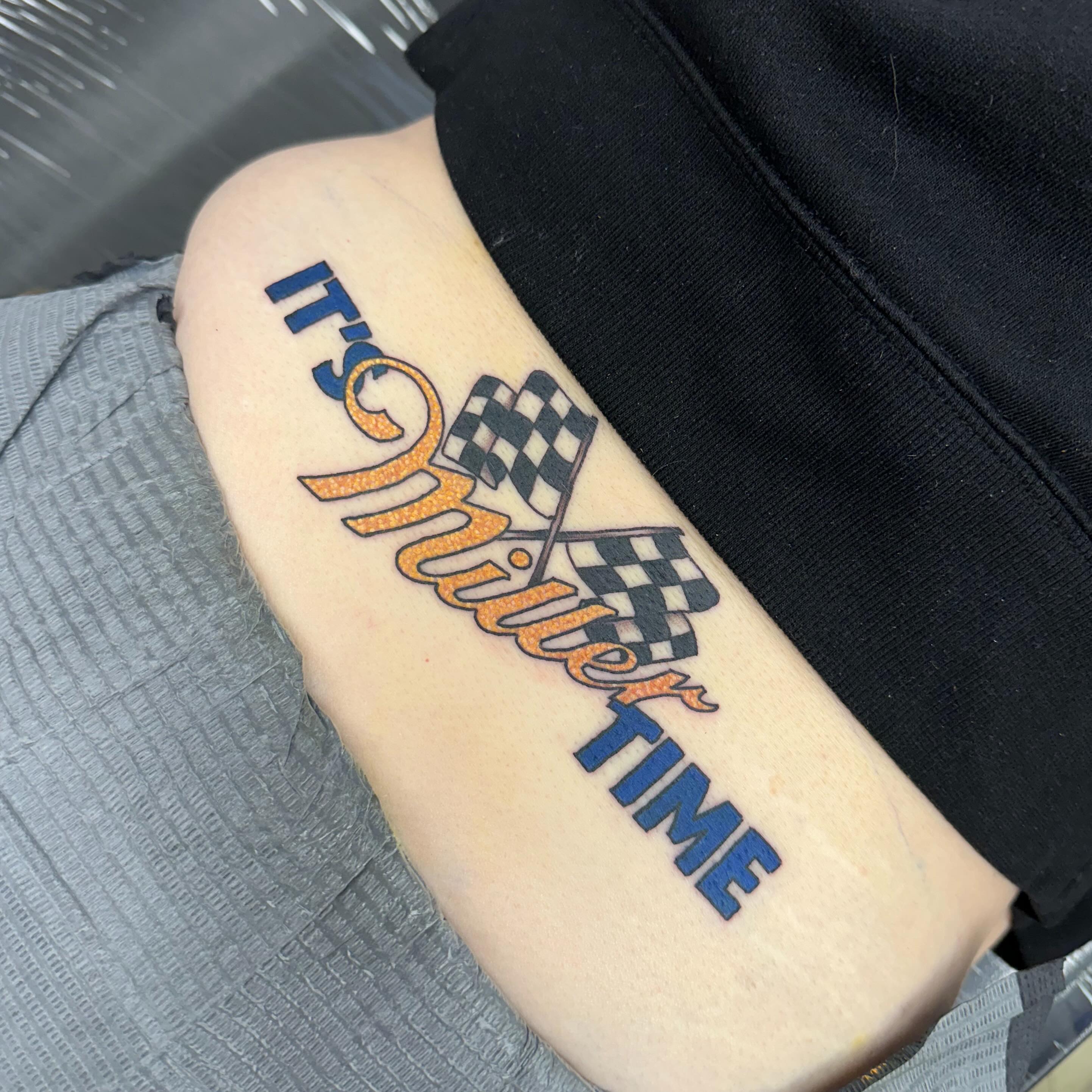 Race car lettering script tattoo on the forearm by Nicki Hoverson