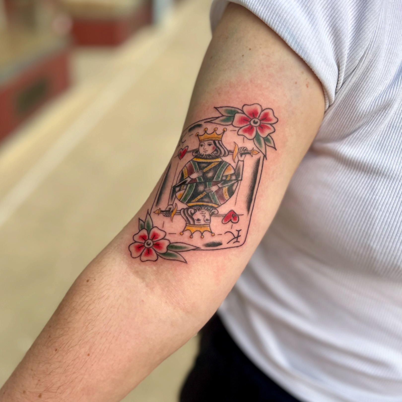 King and flowers American traditional tattoo on the forearm by Tori Magill
