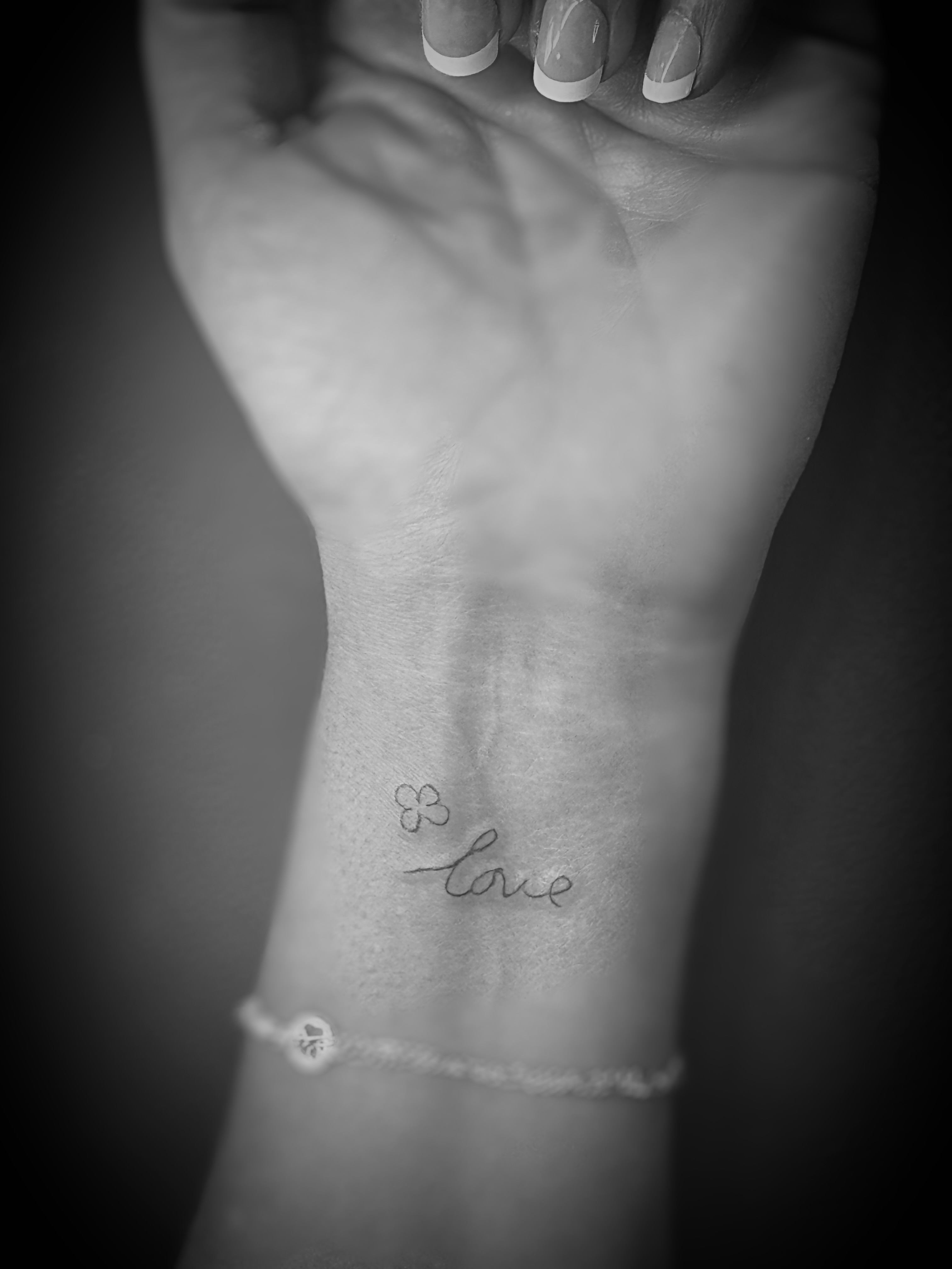 Flower and cursive fine line tattoo on the hand by Meagan, Charlotte, North Carolina