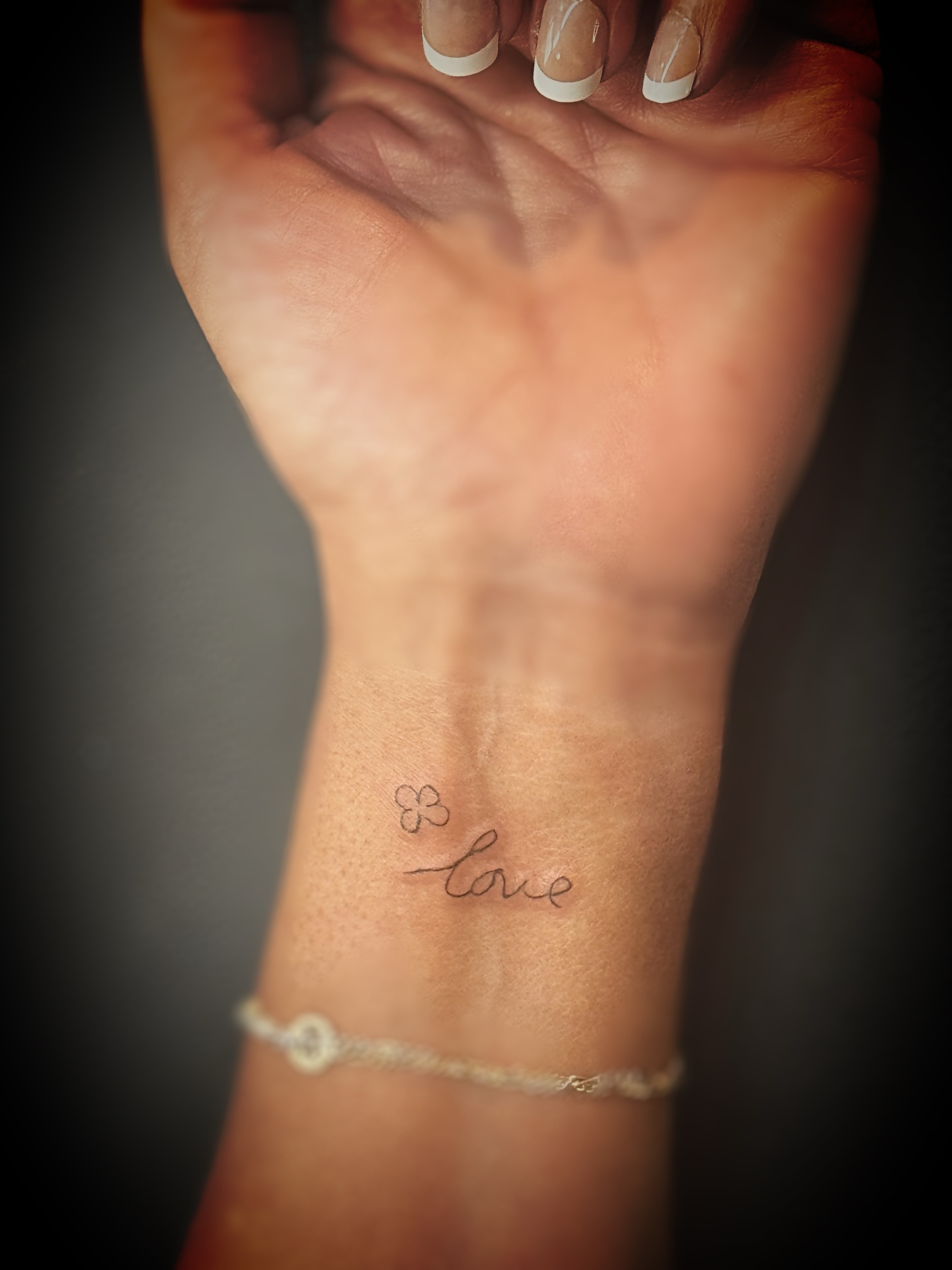 Love lettering script tattoo on the forearm by Meagan, Charlotte, North Carolina
