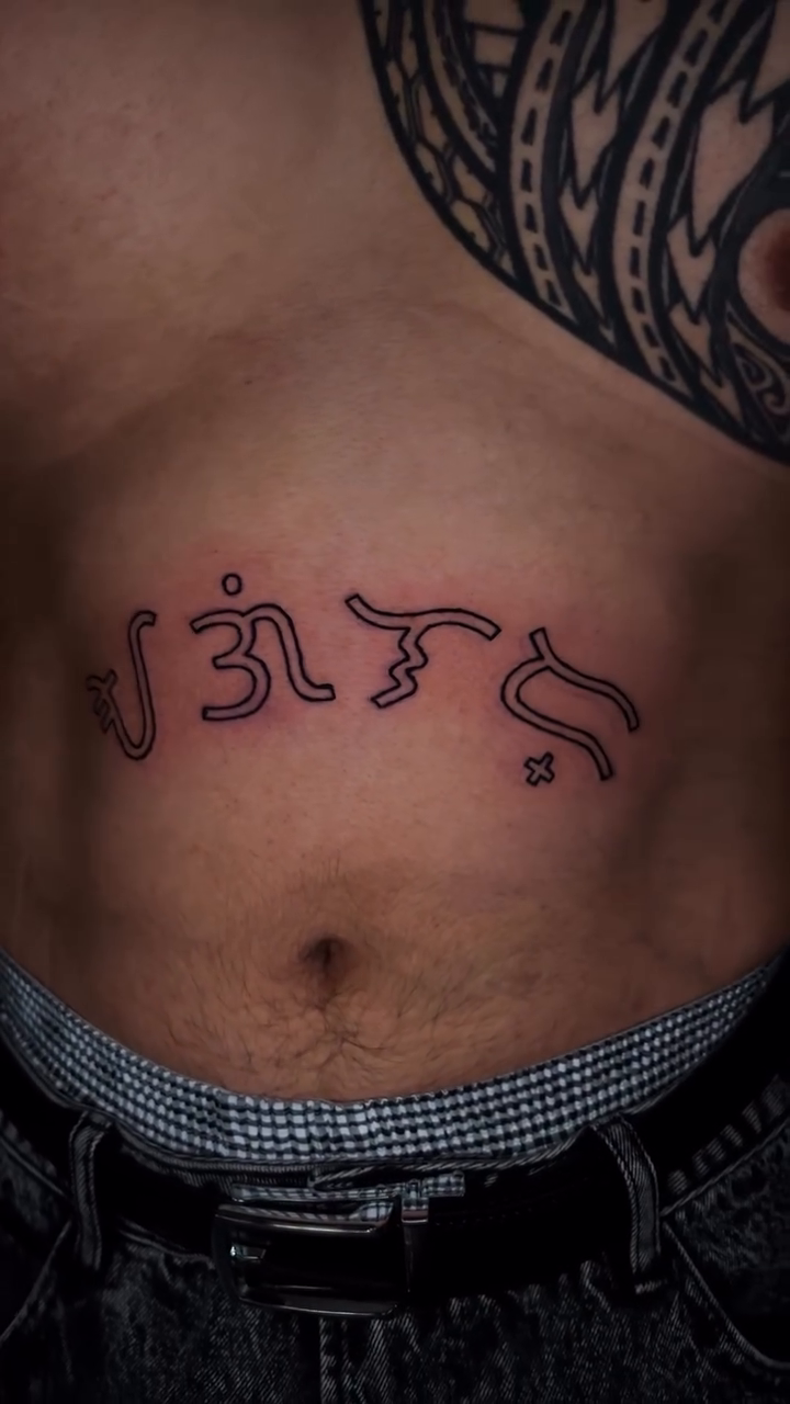 Script tattoo on abdomen blackwork tattoo on the chest by bev