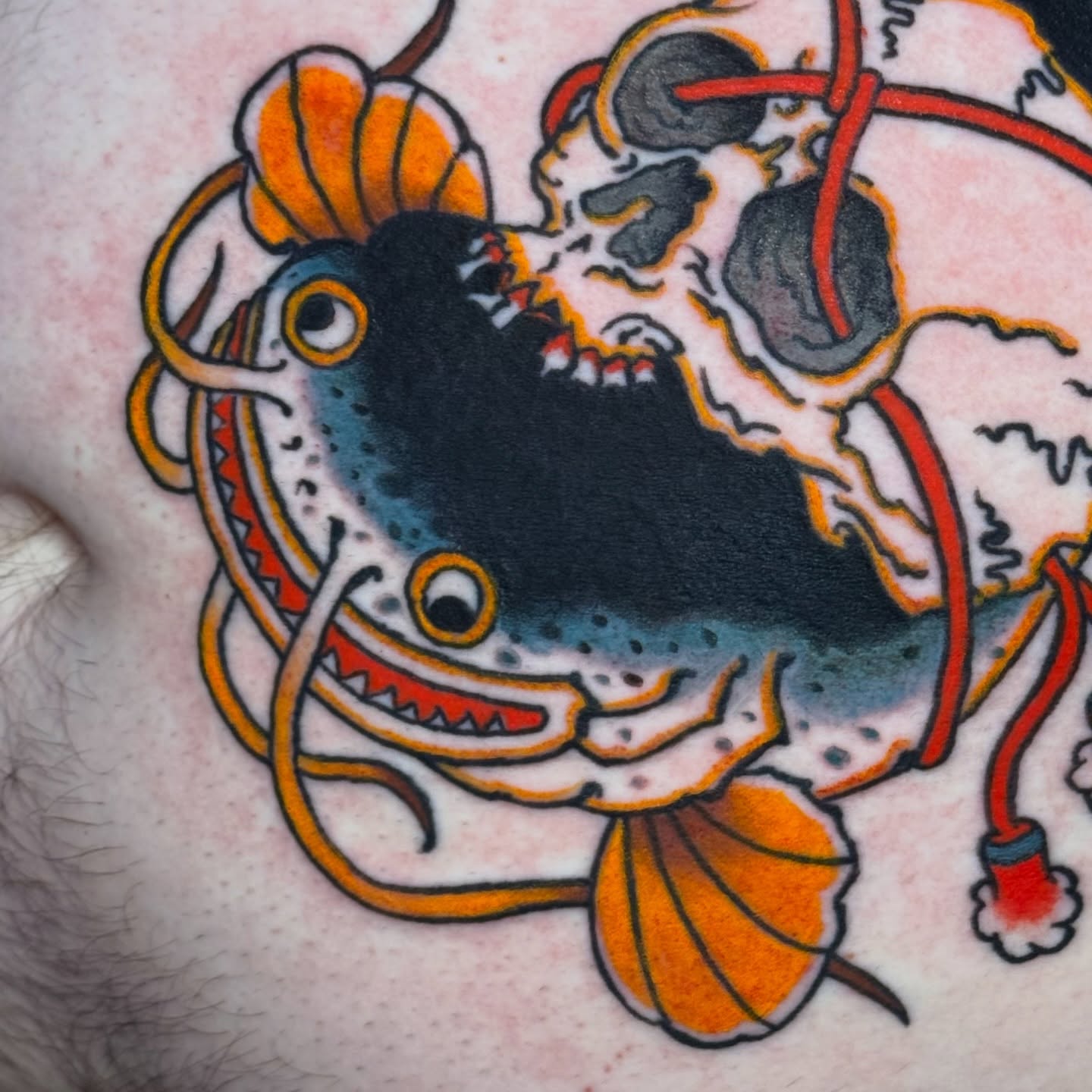 Fish and skull American traditional tattoo on the chest by Matthew - Tattoo Artist