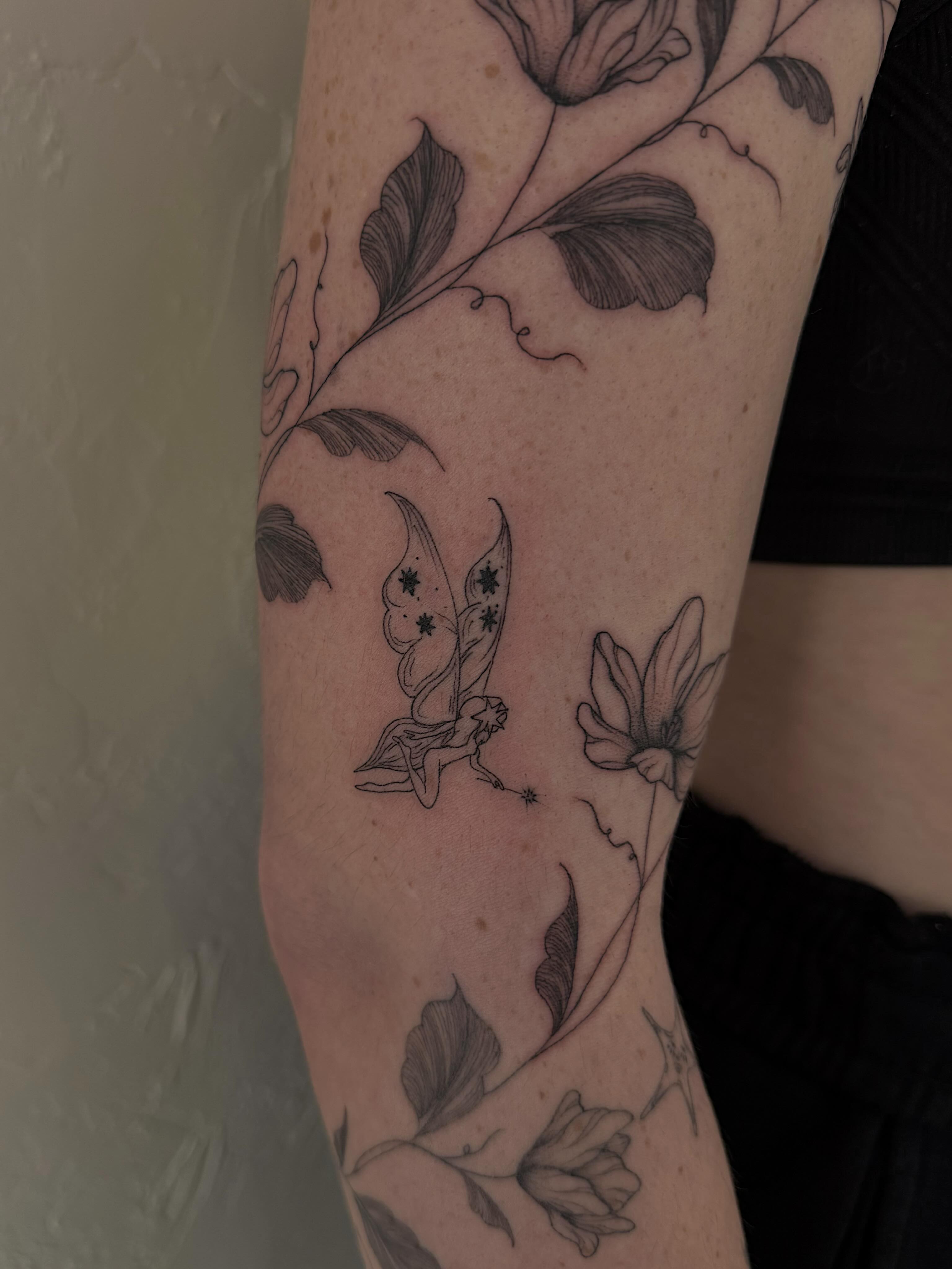 Fairy and flowers black and grey tattoo on the forearm by Shelby Lynn Bayles, Ogden, Utah
