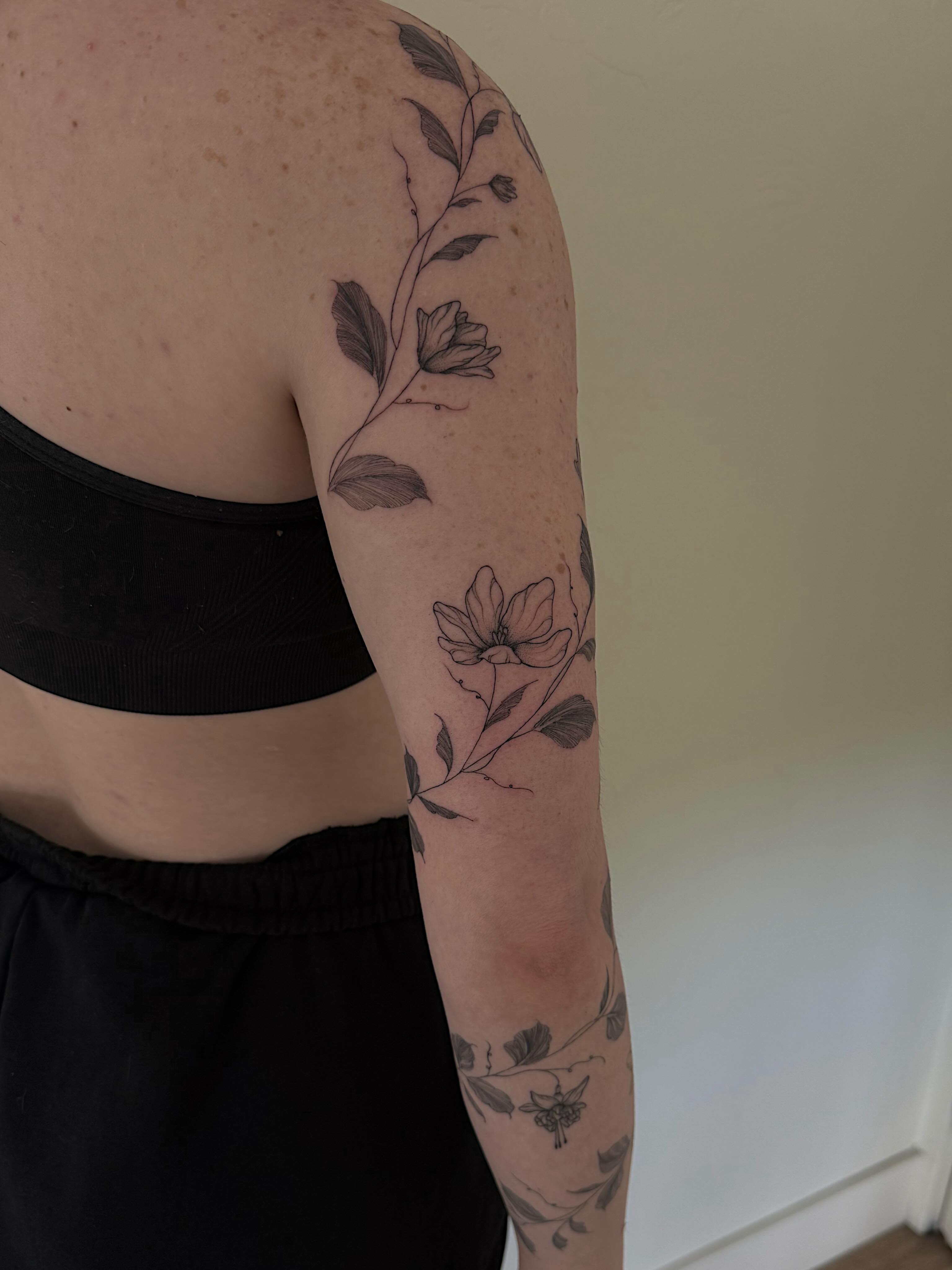 Flower vine black and grey tattoo on the upper arm by Shelby Lynn Bayles, Ogden, Utah
