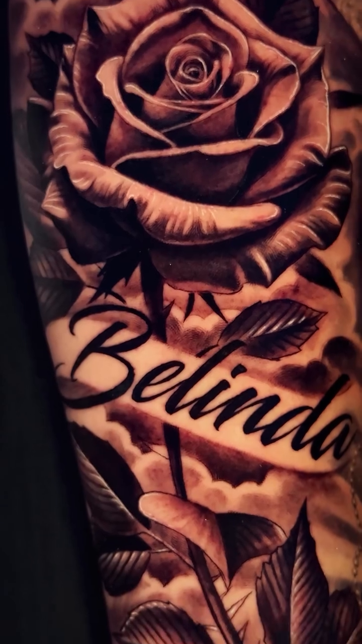 Rose and name tattoo lettering tattoo on the forearm by Raw Hound, Hialeah, Florida