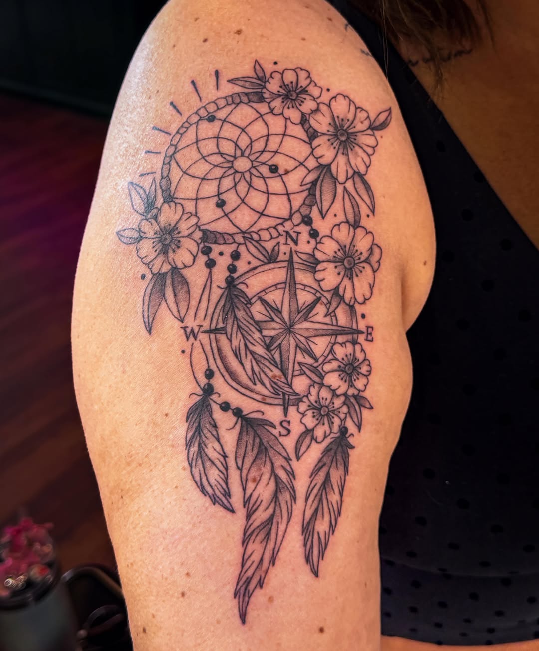 Dreamcatcher and compass black and grey tattoo on the shoulder by Ash✨