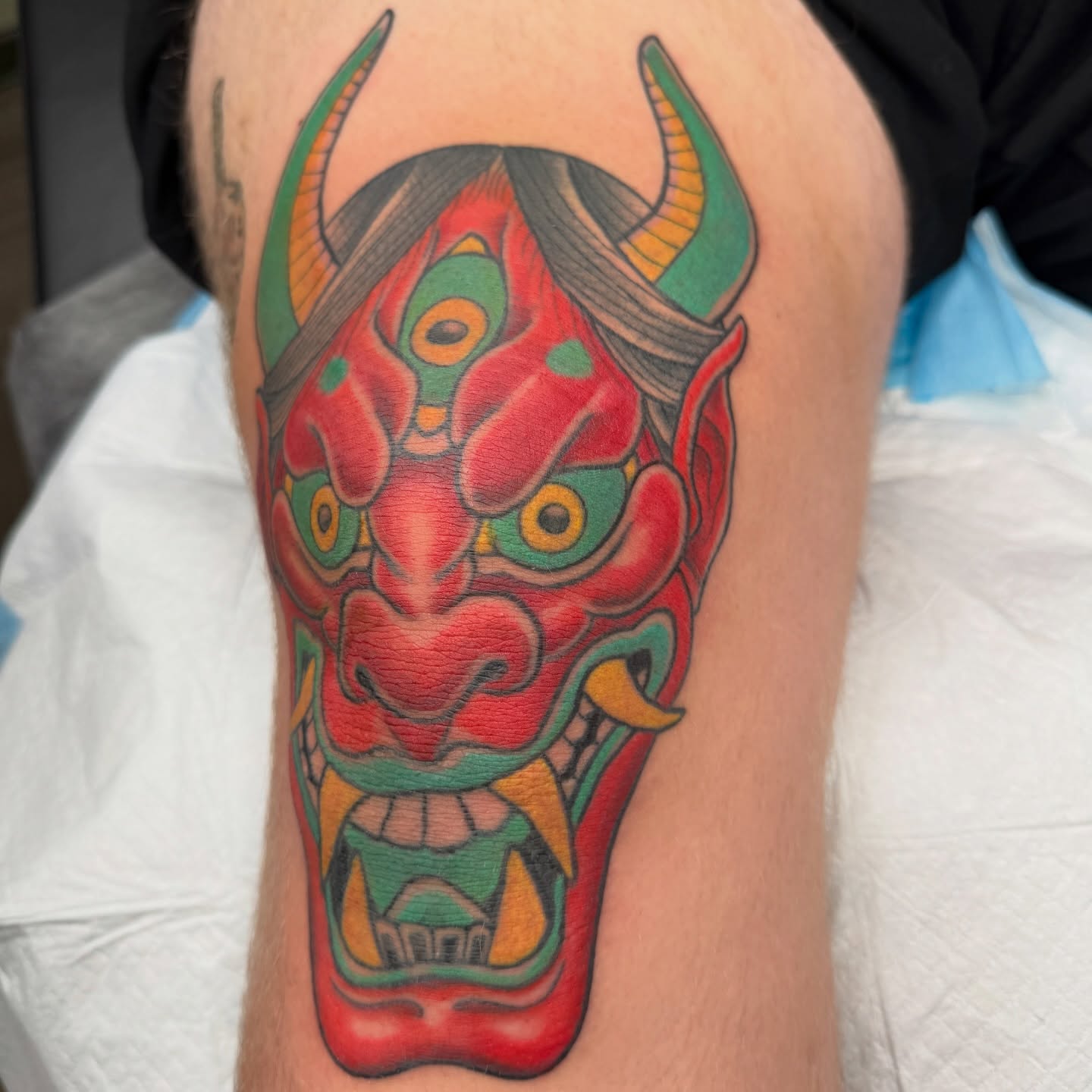 Demon mask japanese irezumi tattoo on the thigh by Joel Smith, Manhattan, Kansas