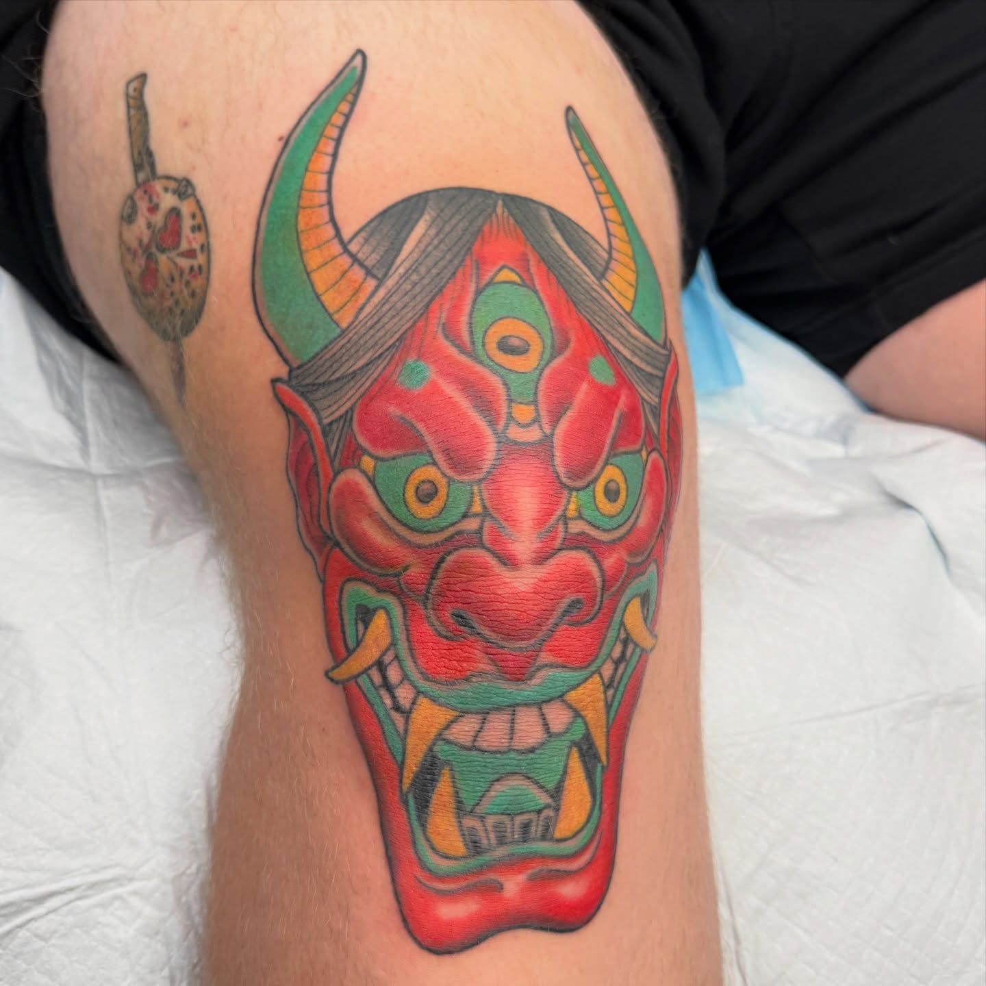 Demon mask japanese irezumi tattoo on the thigh by Joel Smith, Manhattan, Kansas
