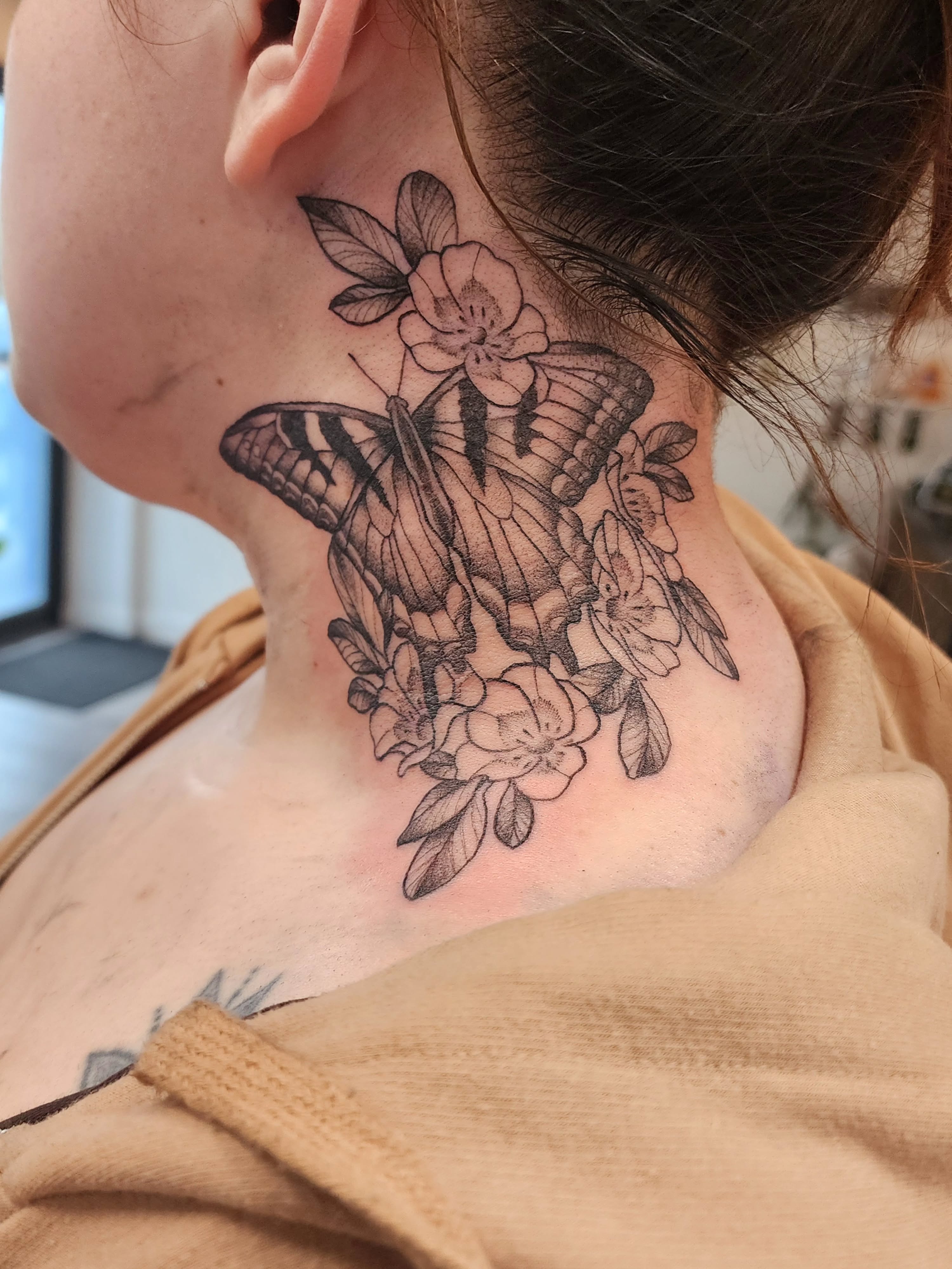 Butterfly and flowers black and grey tattoo on the neck by mikayla