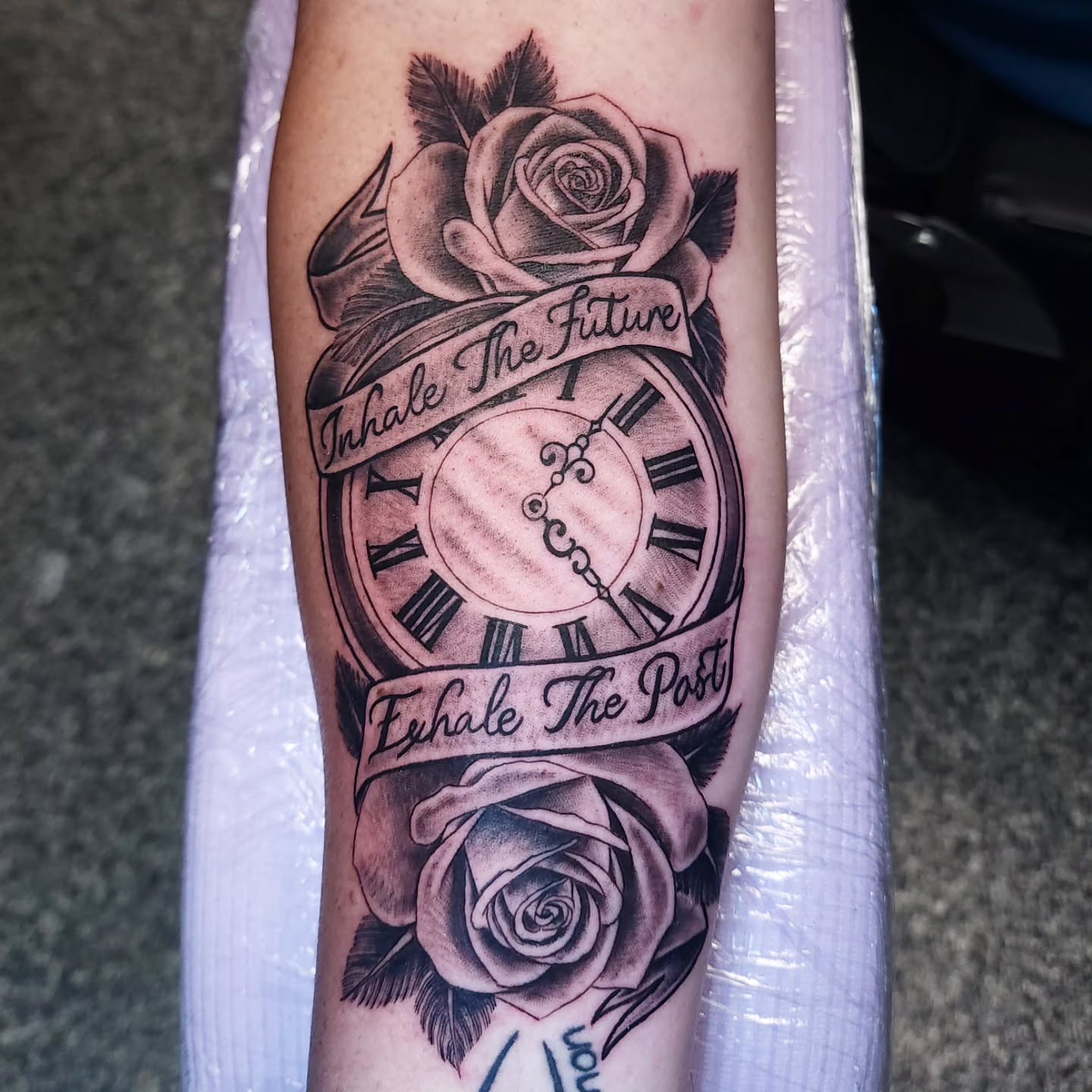 Clock and roses realism tattoo on the forearm by xavia