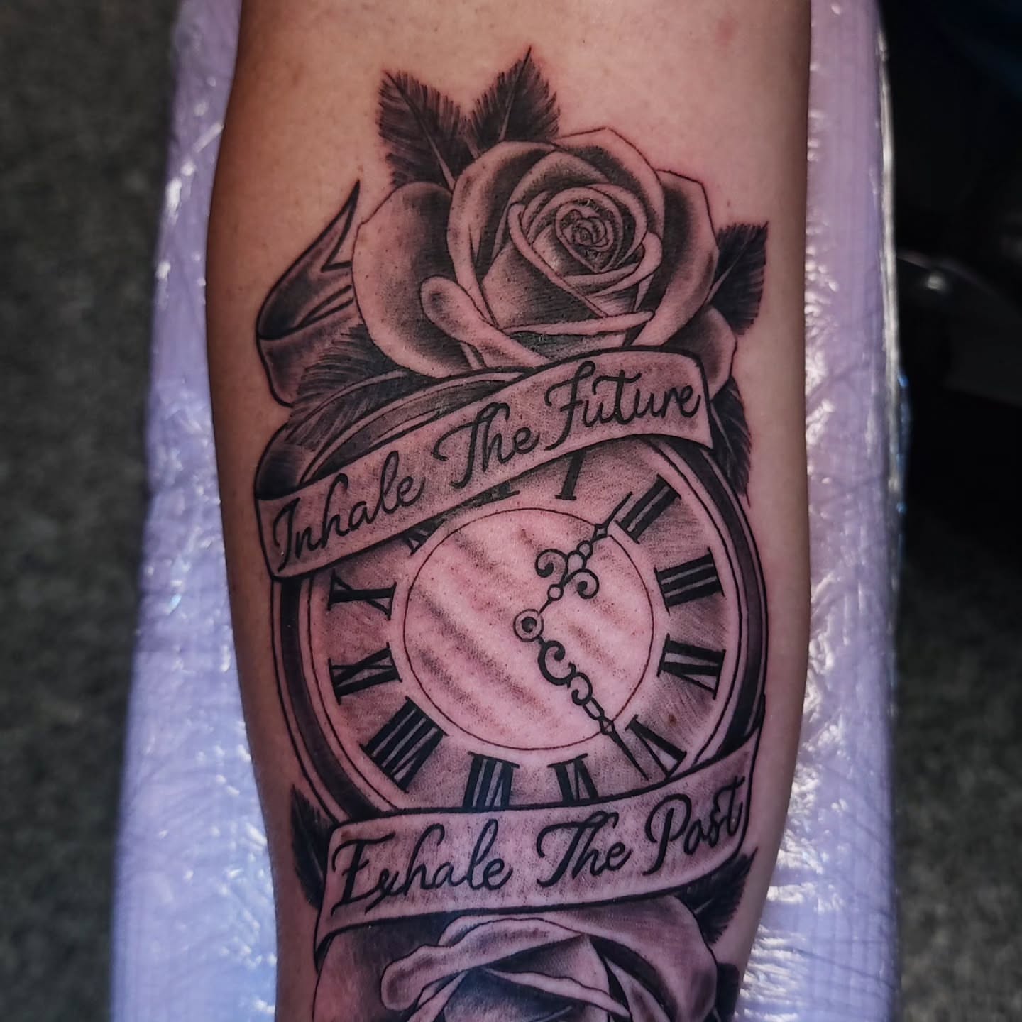 Clock and rose realism tattoo on the forearm by xavia