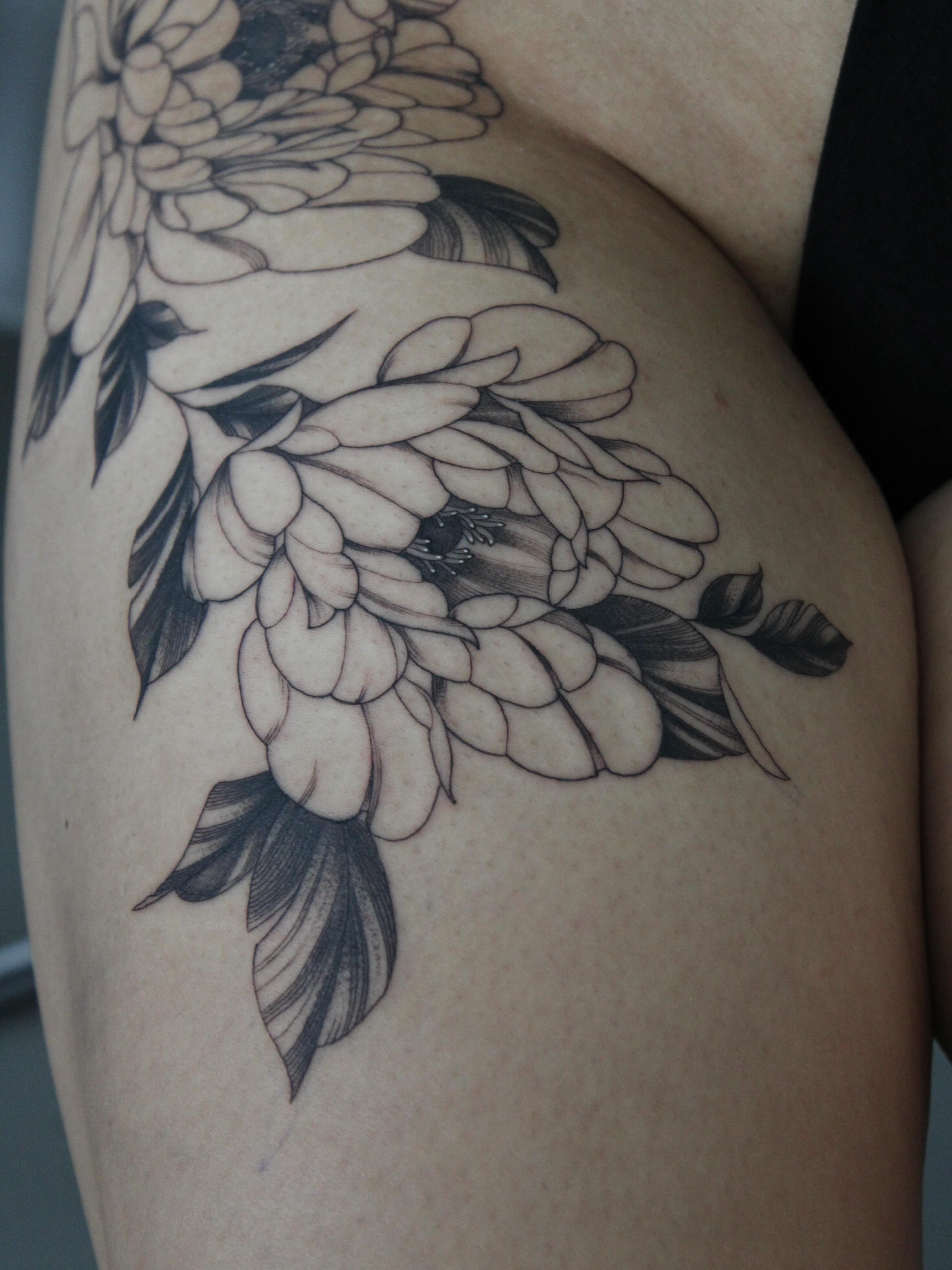 Floral bouquet black and grey tattoo on the thigh by Julianna