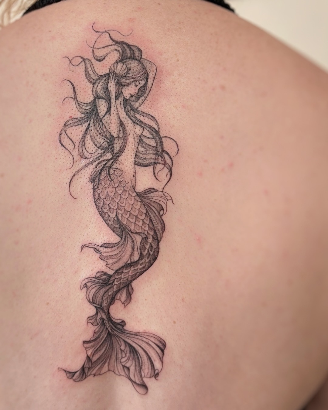 Mermaid dotwork tattoo on the back by jaclyn park