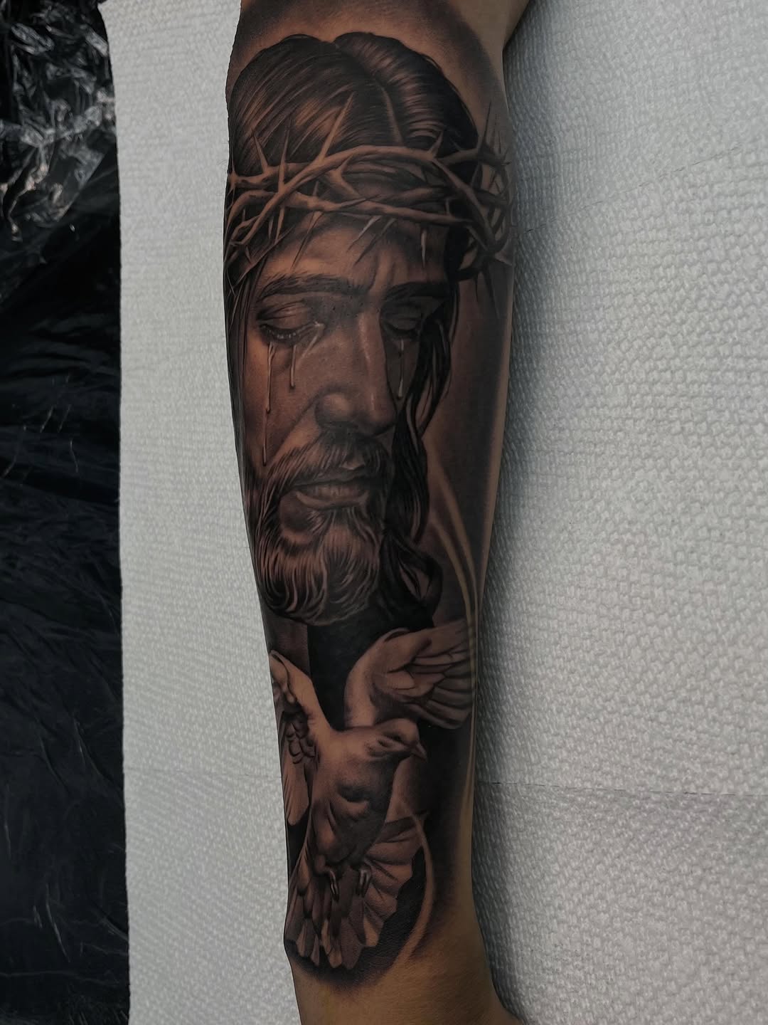 Jesus Christ with a dove Chicano tattoo on the forearm by Denver Tattoo Artist