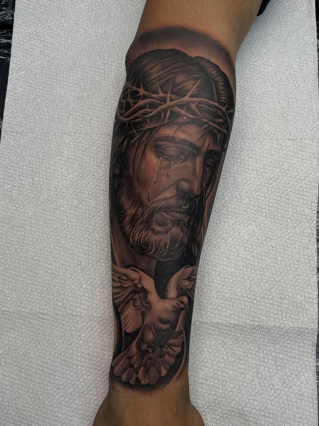 Jesus Christ with a dove Chicano tattoo on the forearm by Denver Tattoo Artist