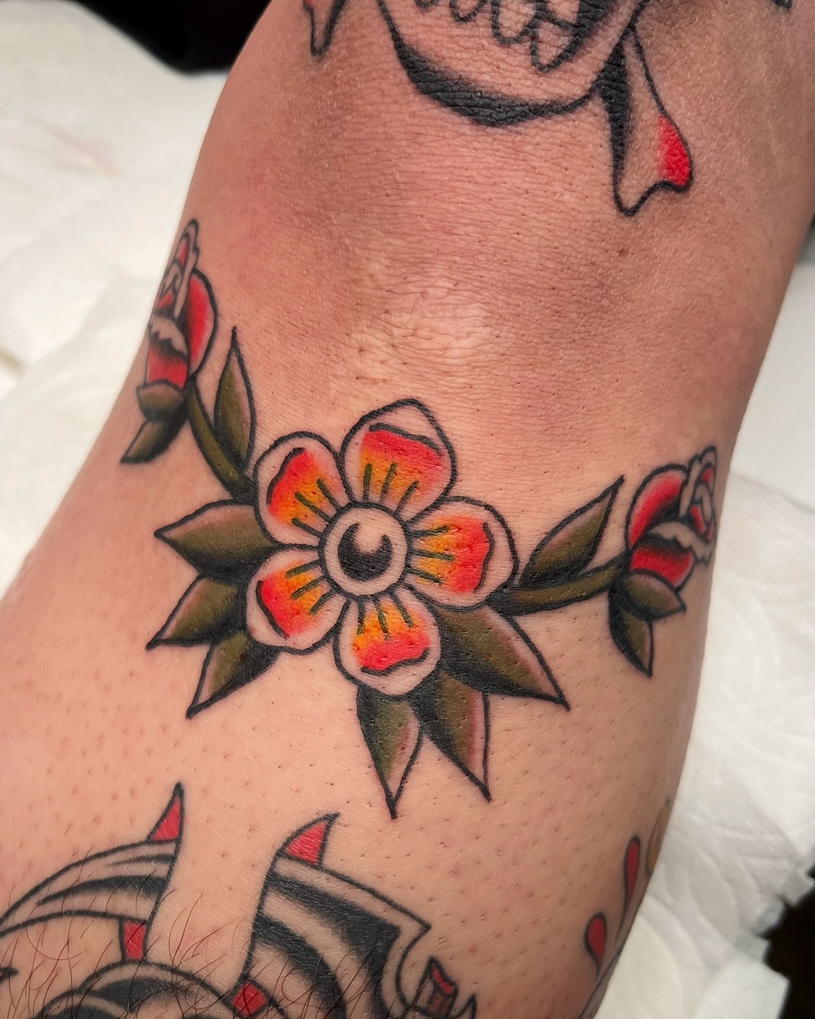 Floral design American traditional tattoo on the forearm by Tiffani Thompson, San Diego, California