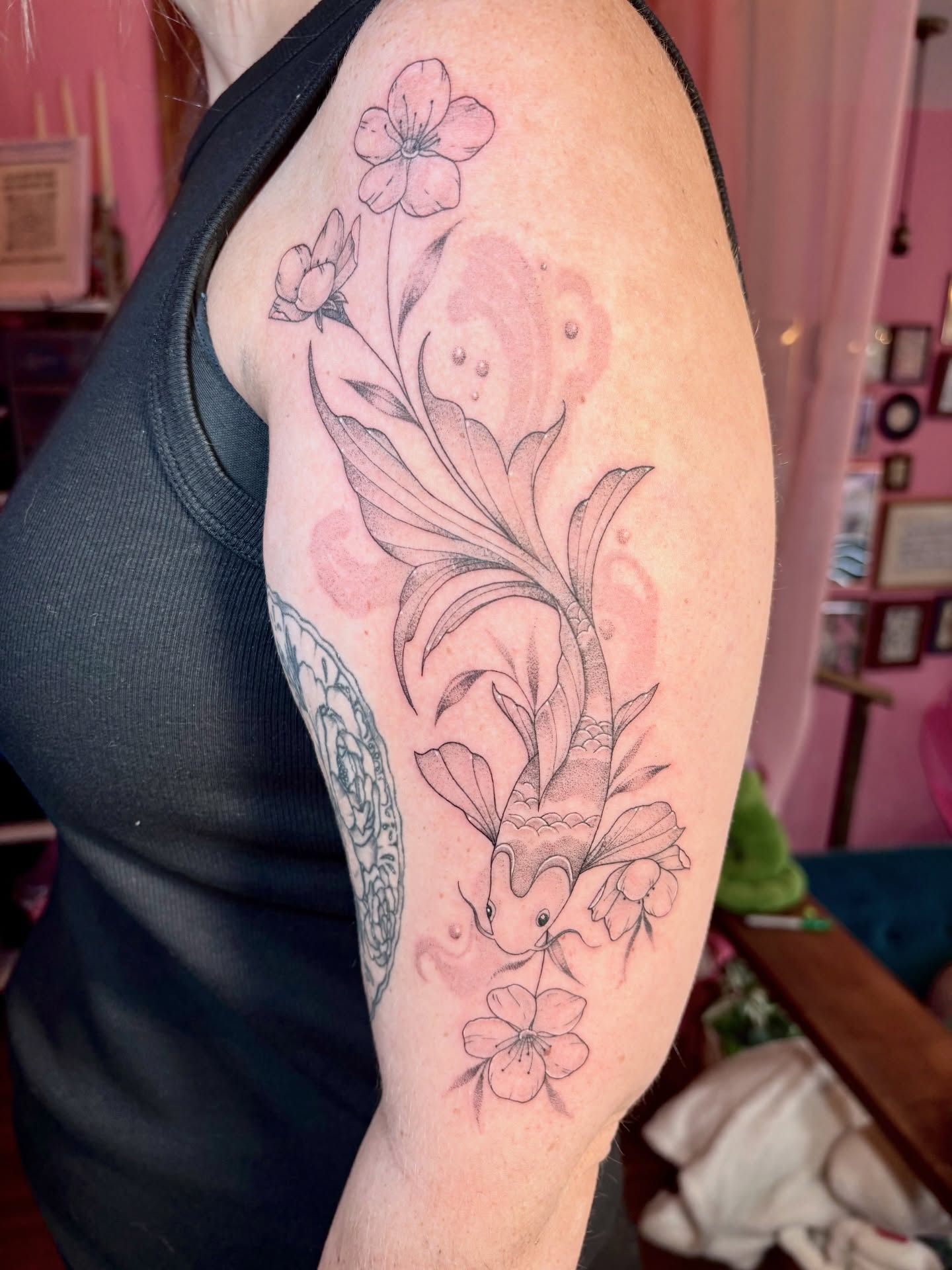 Koi fish and flowers black and grey tattoo on the forearm by Charlotte Brown, Leeds, England