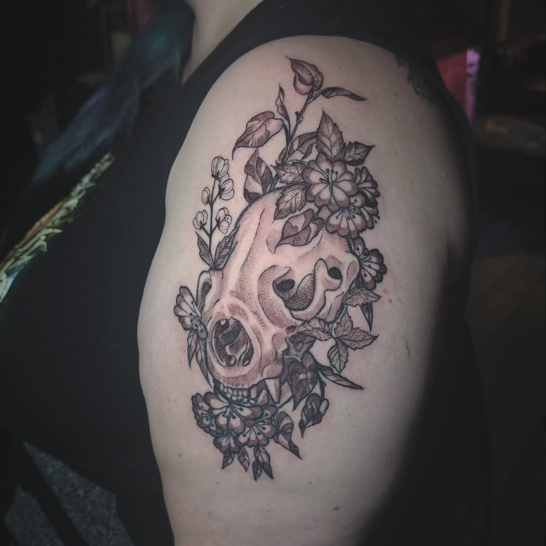 Skull and flowers black and grey tattoo on the shoulder by Casey Jo