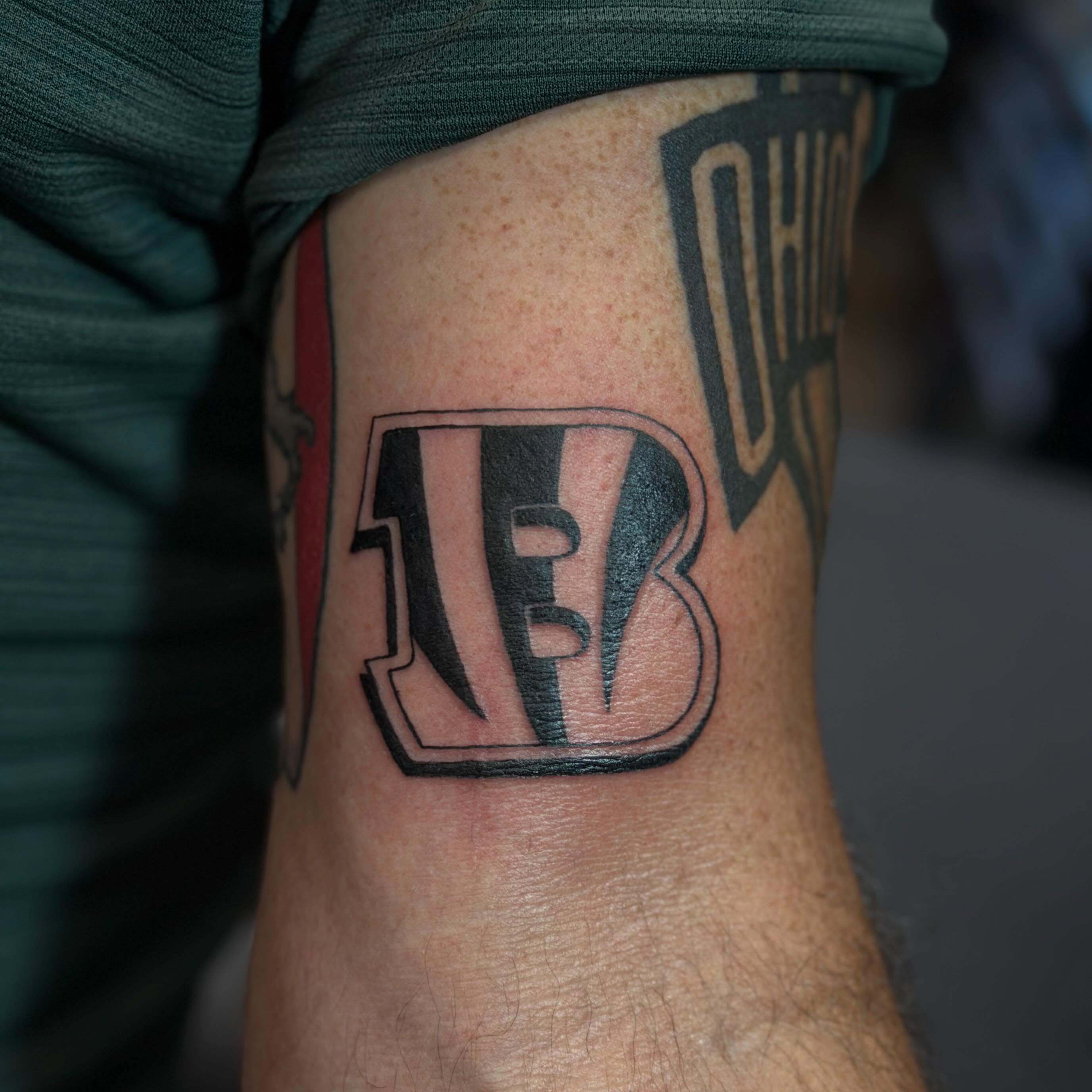 Cincinnati Bengals logo black and grey tattoo on the forearm by Trista Bettfreund (Birdy)