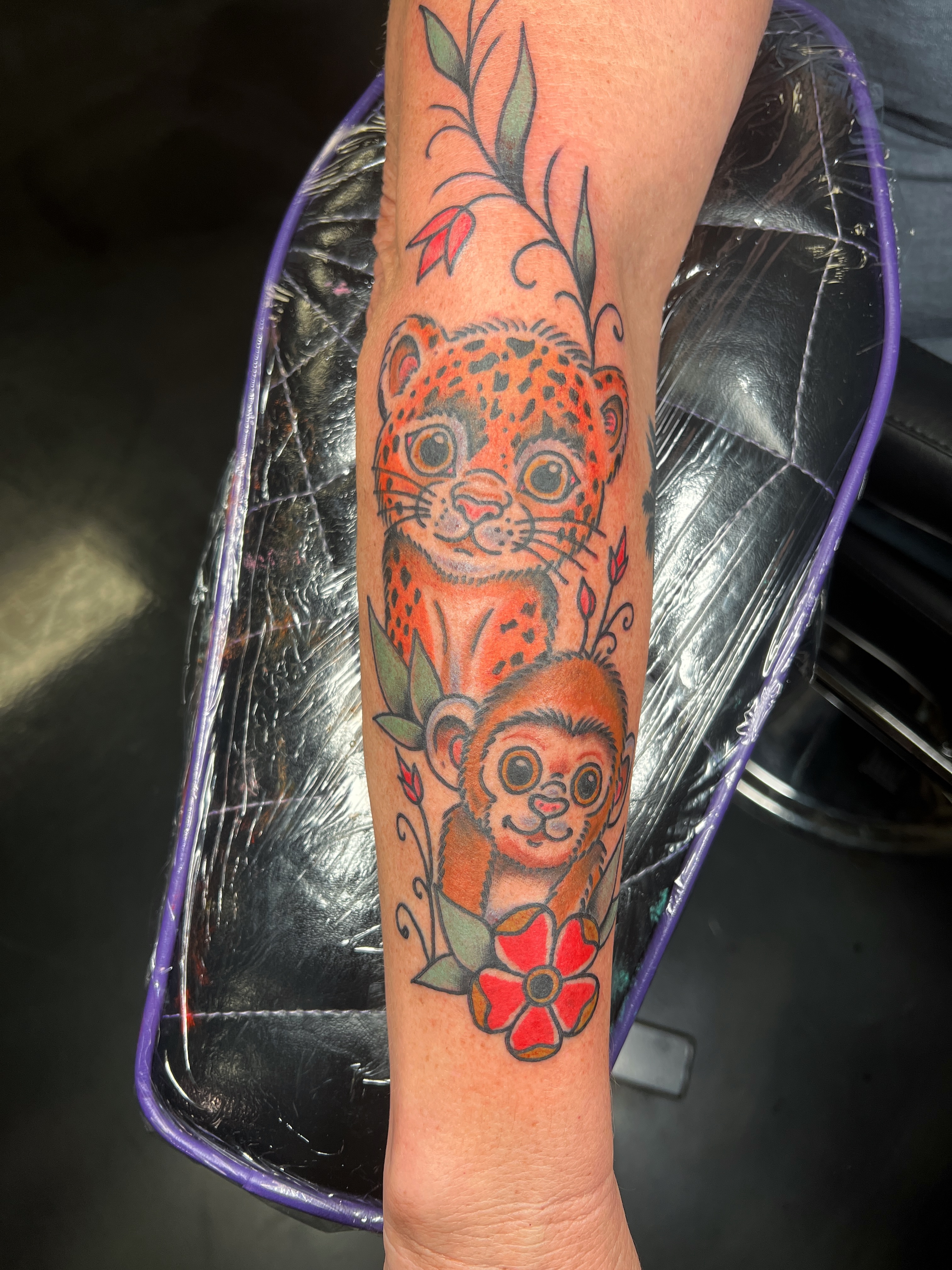 Jaguar and monkey American traditional tattoo on the forearm by Brian Mock