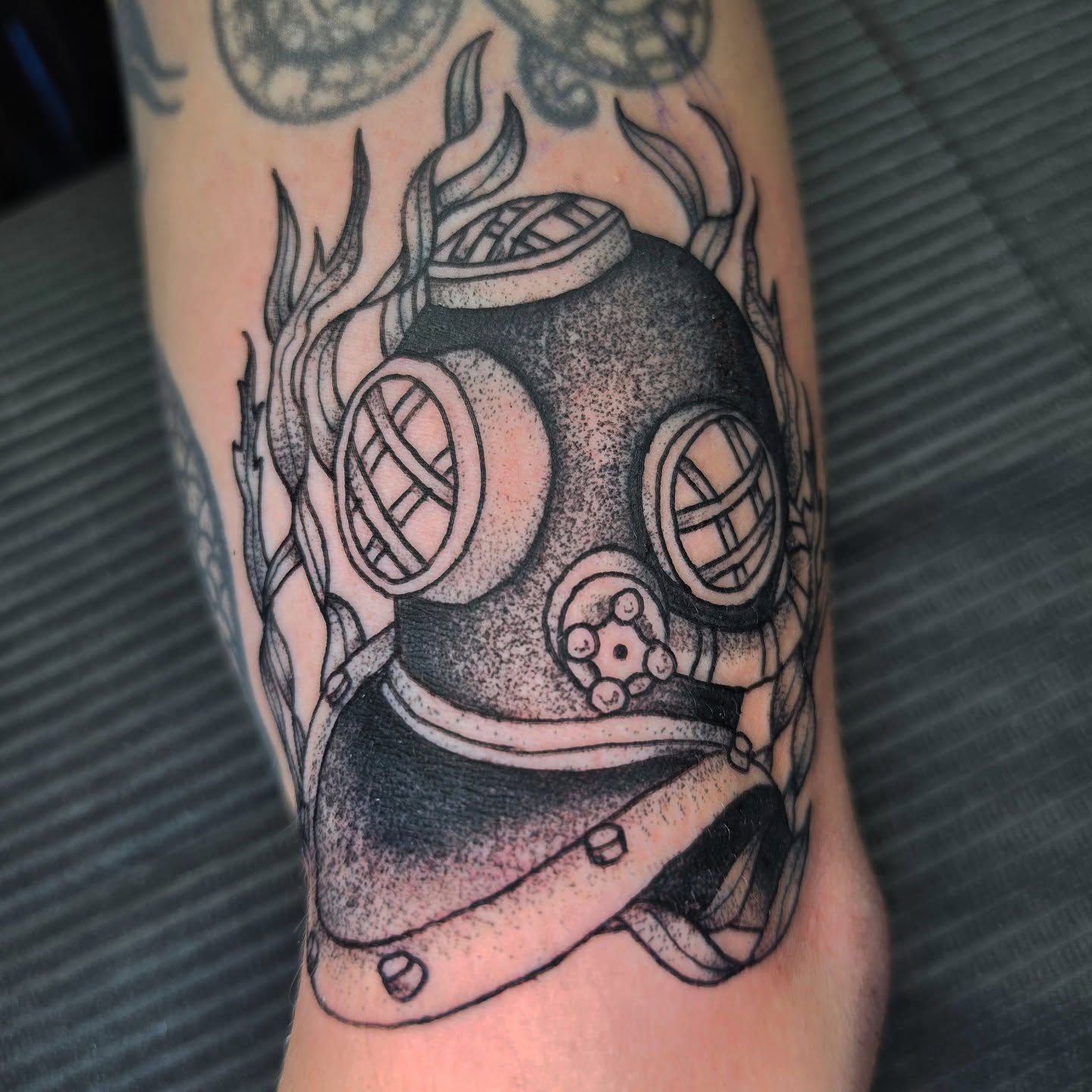 Diving helmet dotwork tattoo on the forearm by Oliver Ⴟ Graves