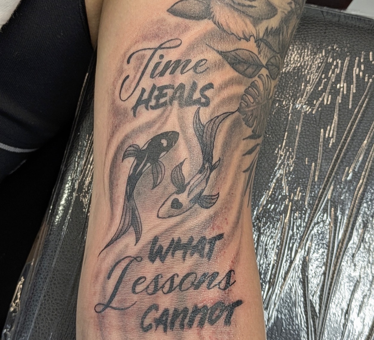 Time heals lessons black and grey tattoo on the forearm by Buddy K.