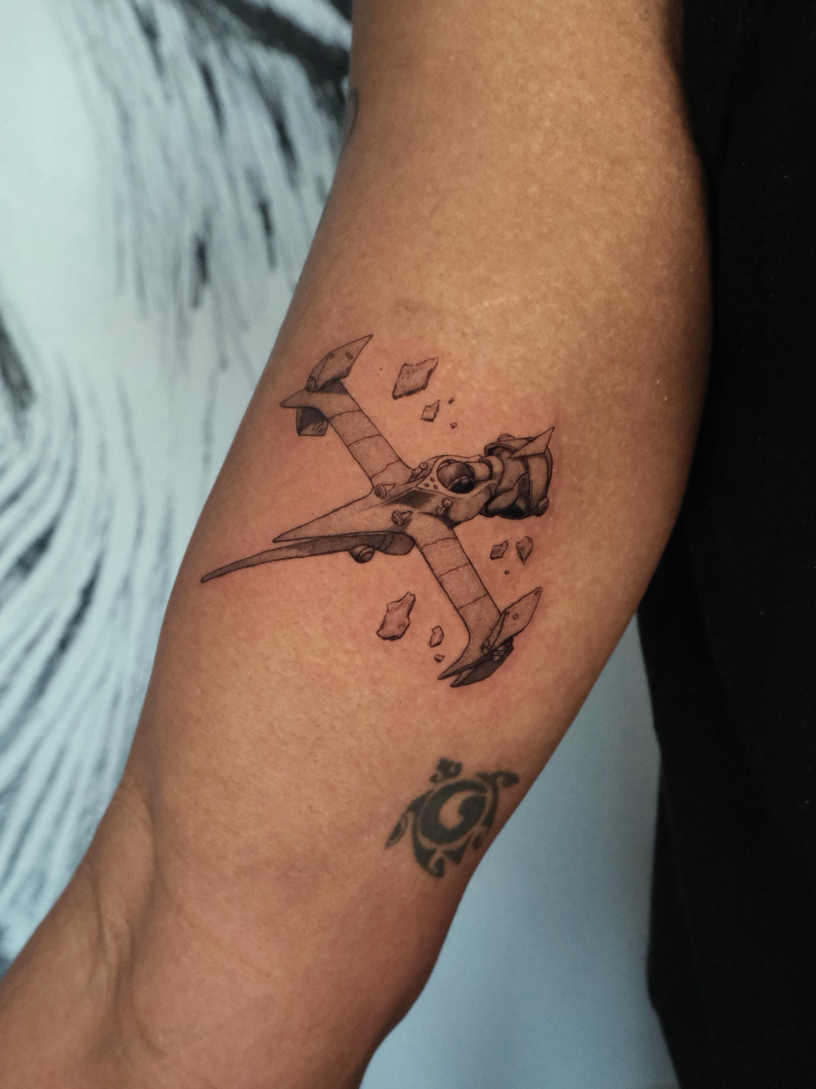 Airplane black and grey tattoo on the forearm by HanaKaki