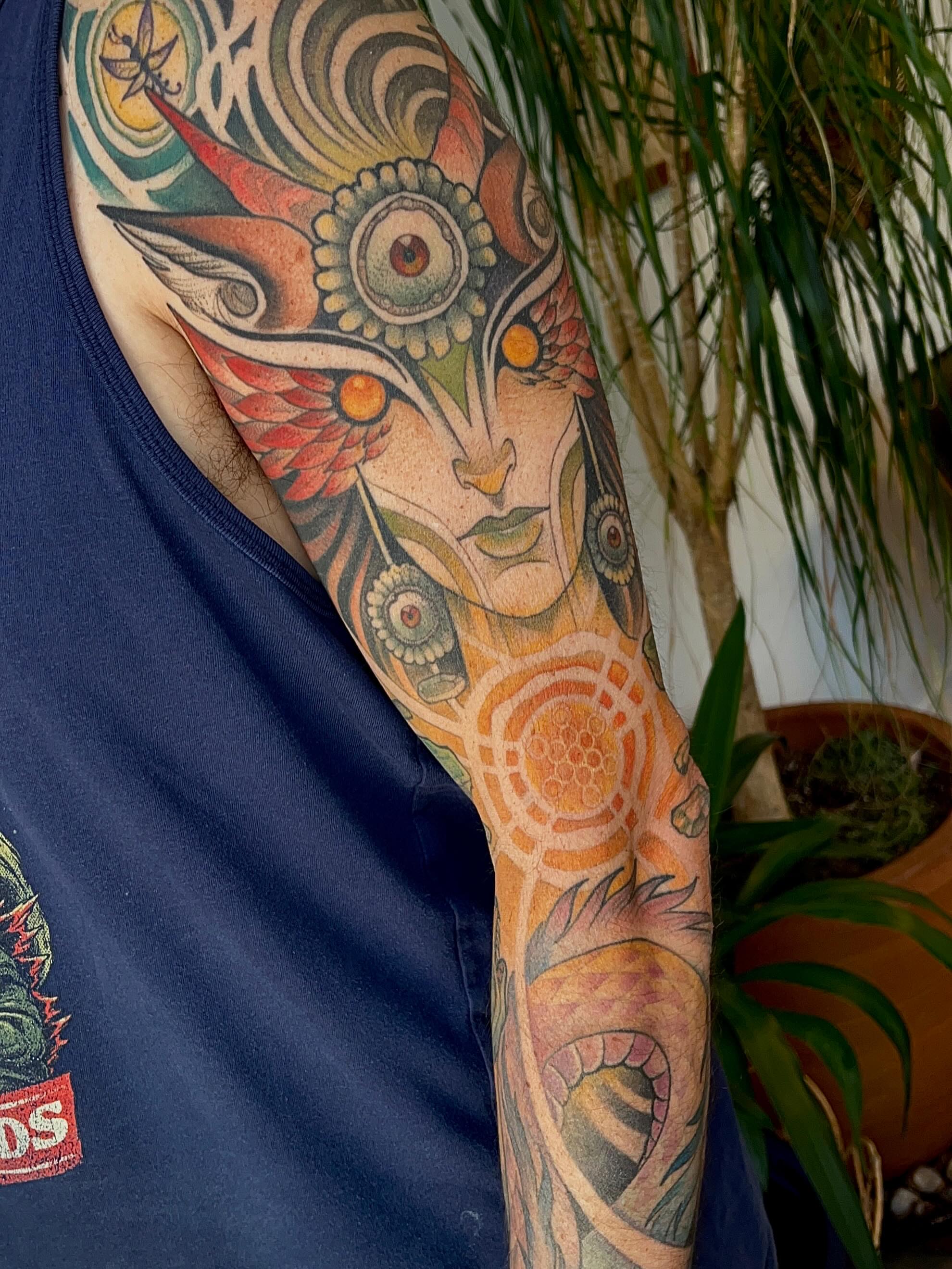 Abstract face geometric tattoo on the upper arm by Samantha Castrovinci, Durham, North Carolina