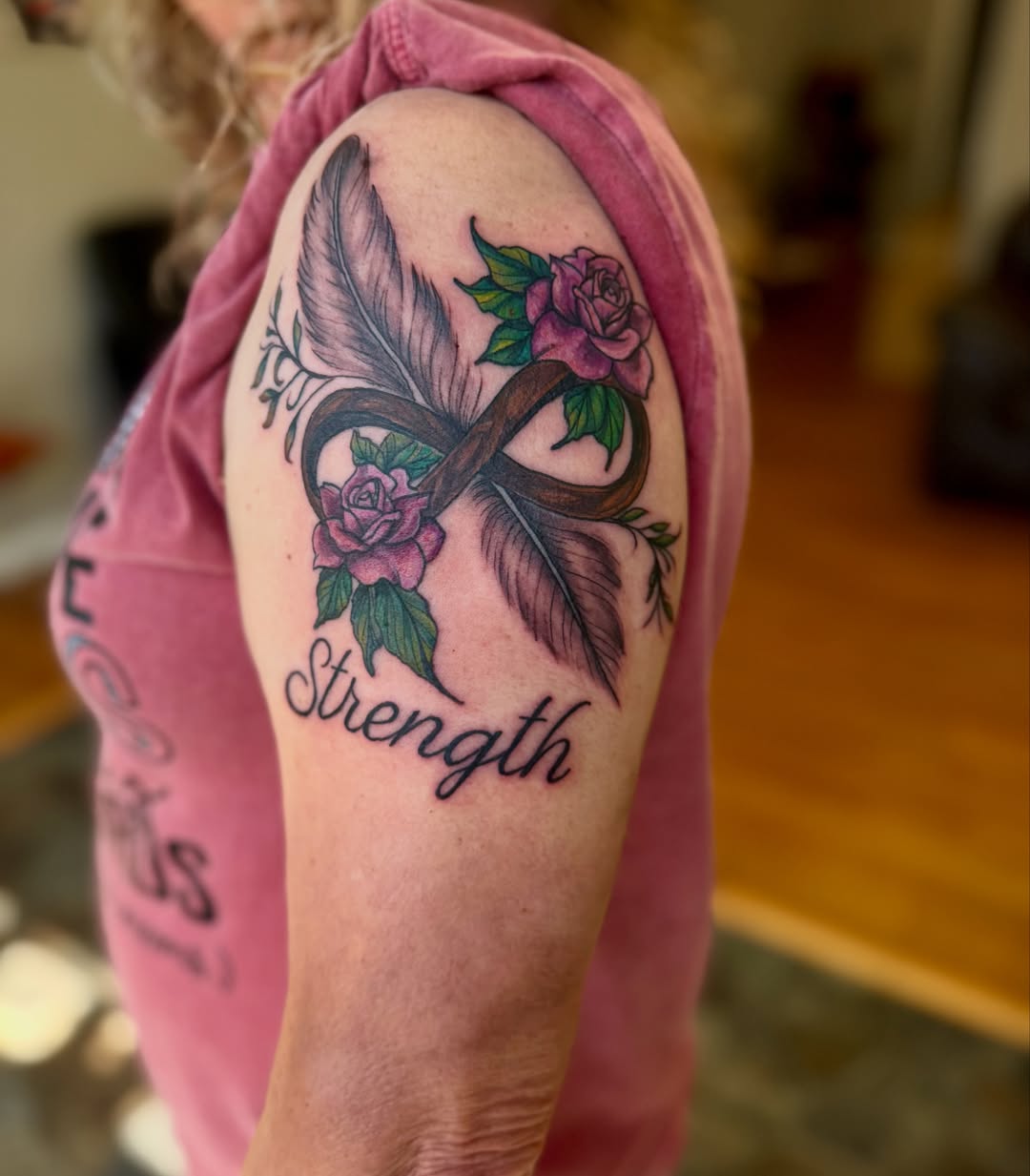 Infinity symbol with roses neo-traditional tattoo on the shoulder by Skylar Sheeley
