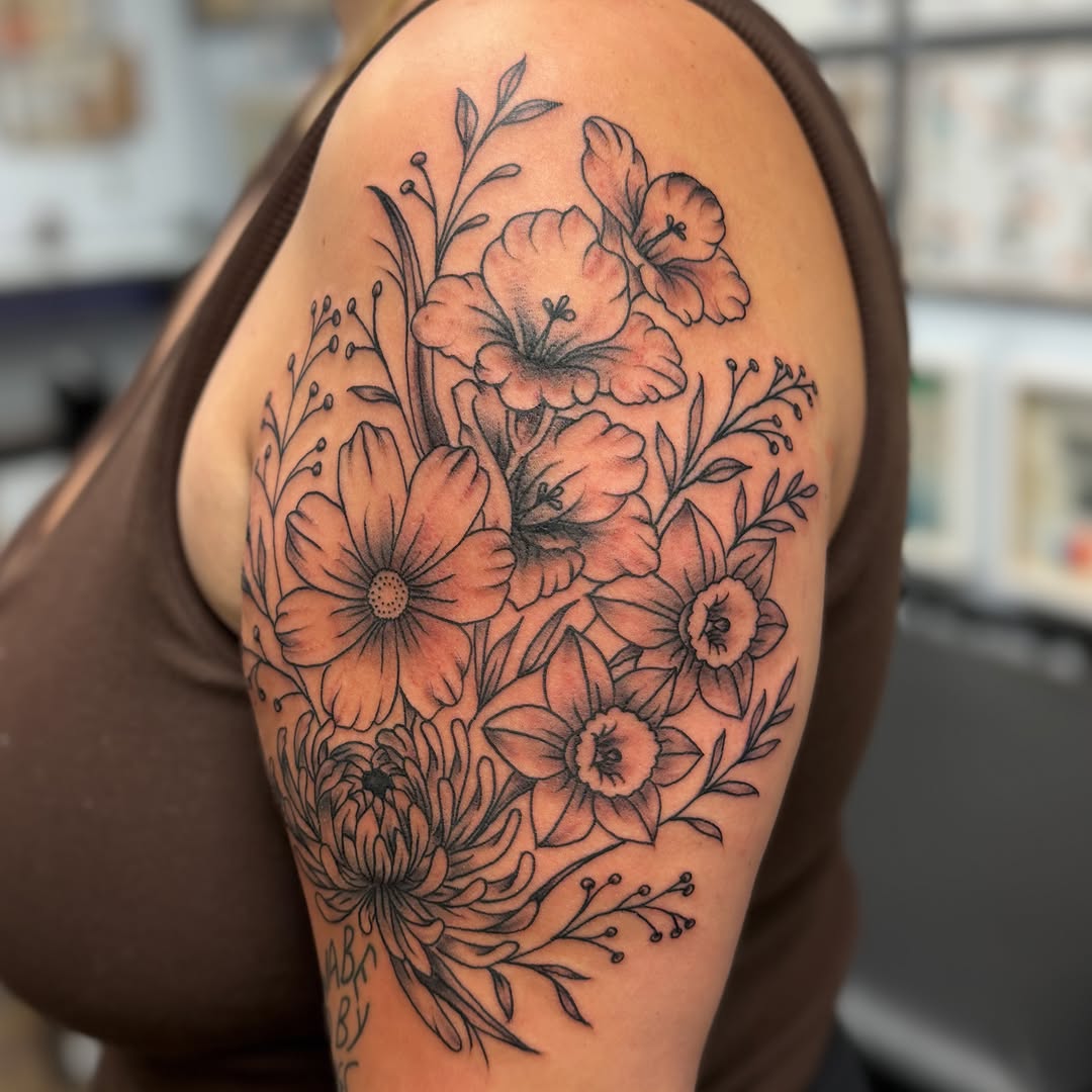 Floral bouquet black and grey tattoo on the shoulder by Zac Tattooer