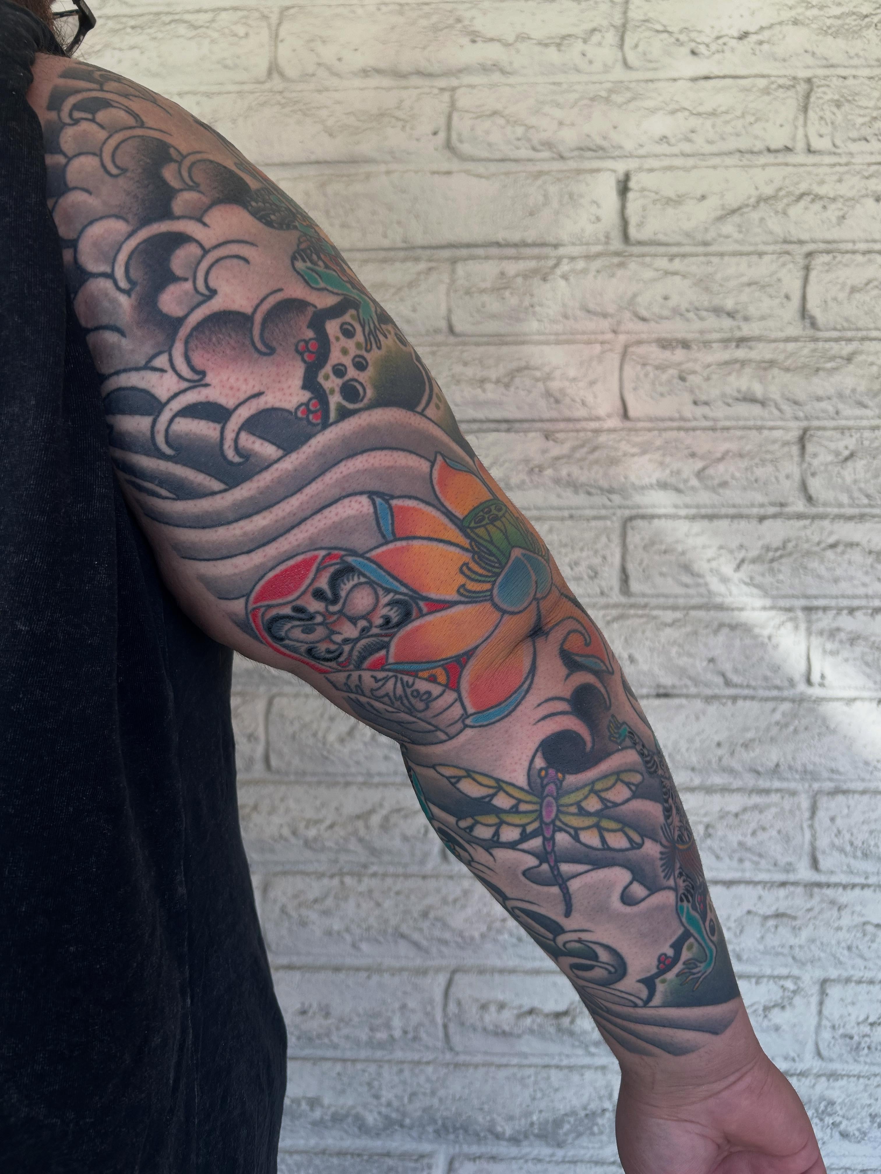Wave and dragonfly japanese irezumi tattoo on the forearm by Stephen Sanchez