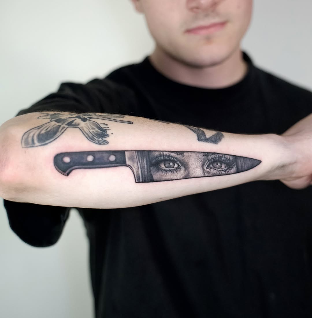 Knife and eyes realism tattoo on the forearm by @lovechasetattoo
