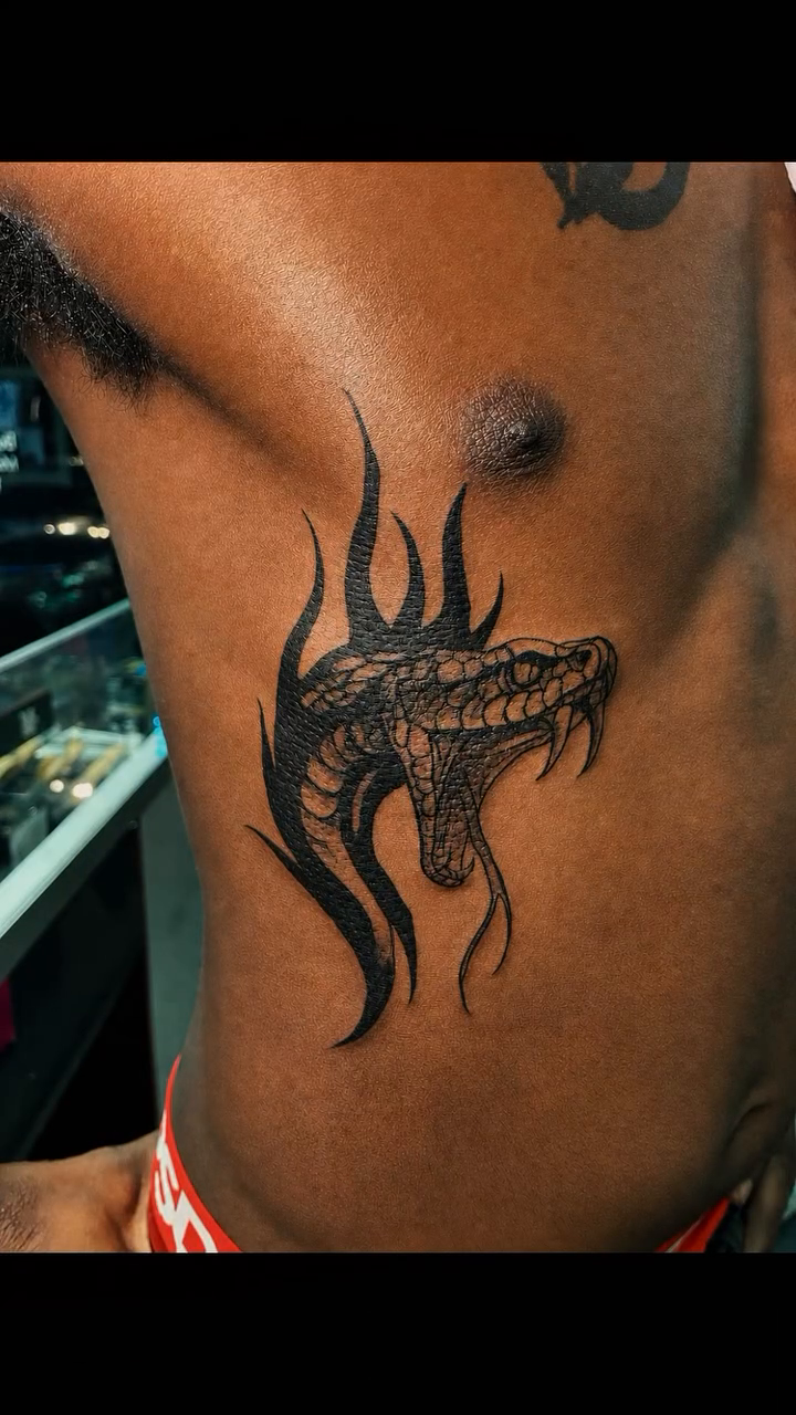 Snake tattoo on chest blackwork tattoo on the chest by 𝚃𝙰𝚃𝚃𝙾𝙾 𝙰𝚁𝚃𝙸𝚂𝚃, Charlotte, North Carolina
