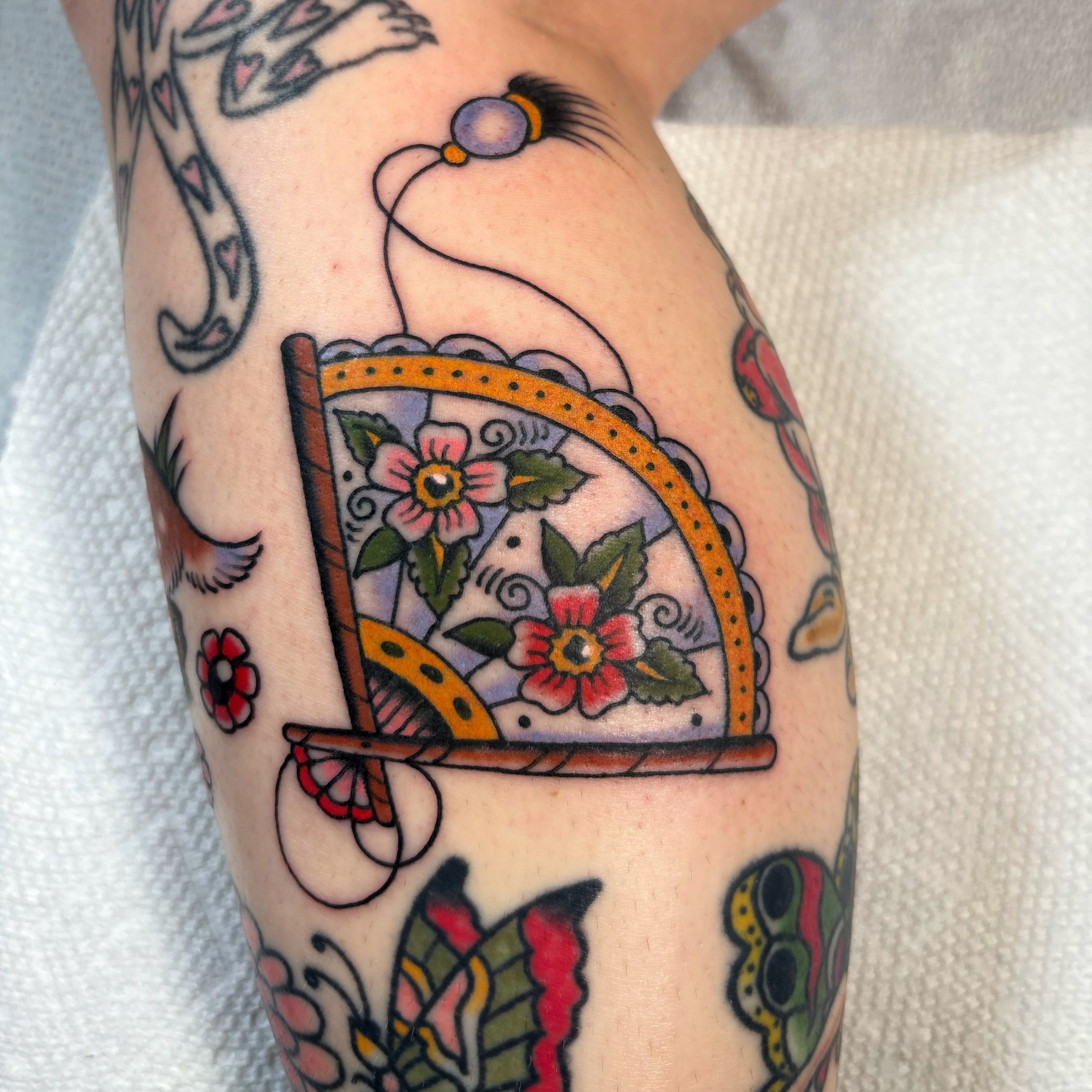 Window with flowers American traditional tattoo on the forearm by Caeli Martin
