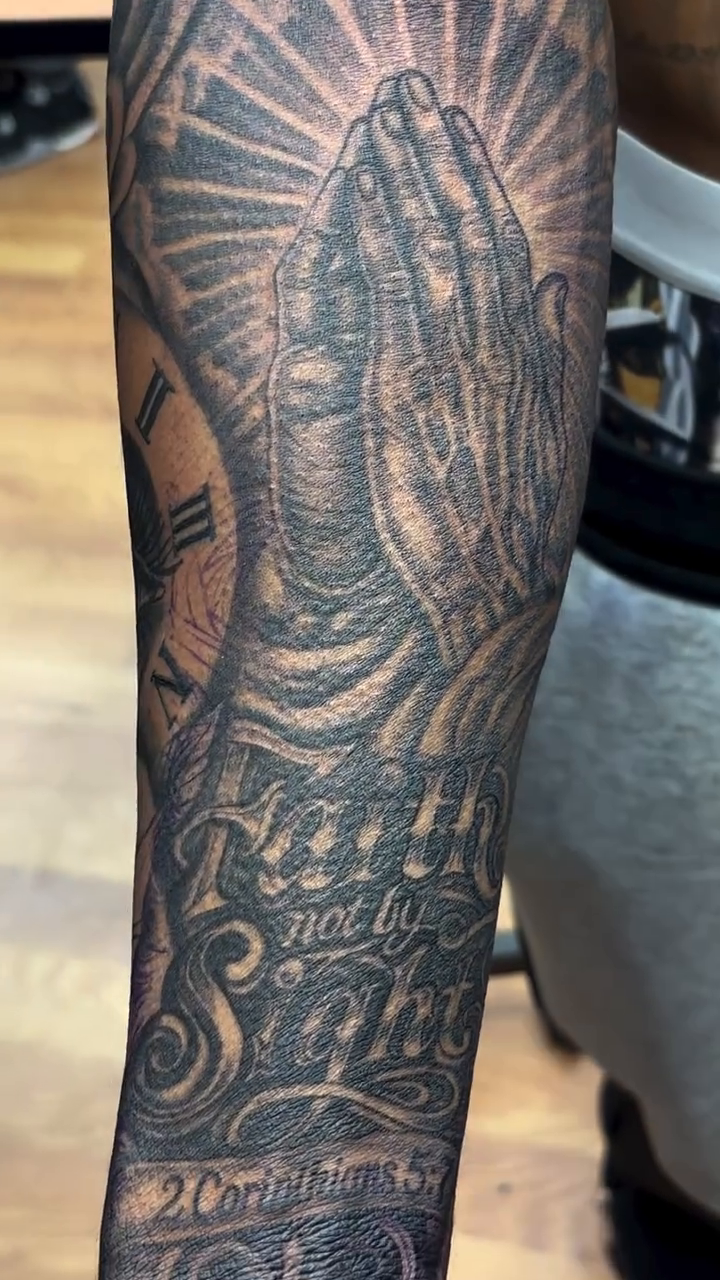 Praying hands and religious imagery realism tattoo by Thomas