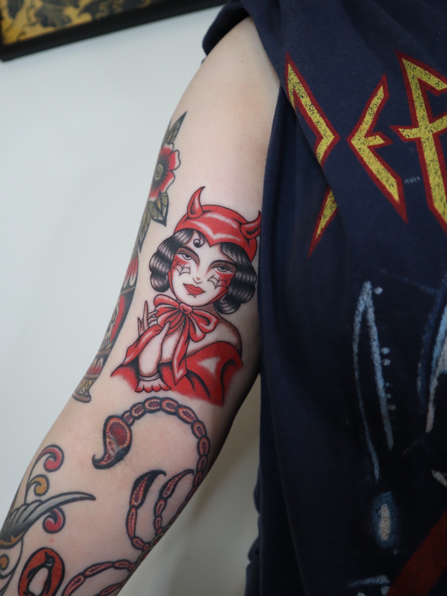 Woman with horns American traditional tattoo on the forearm by Kate Ortiz