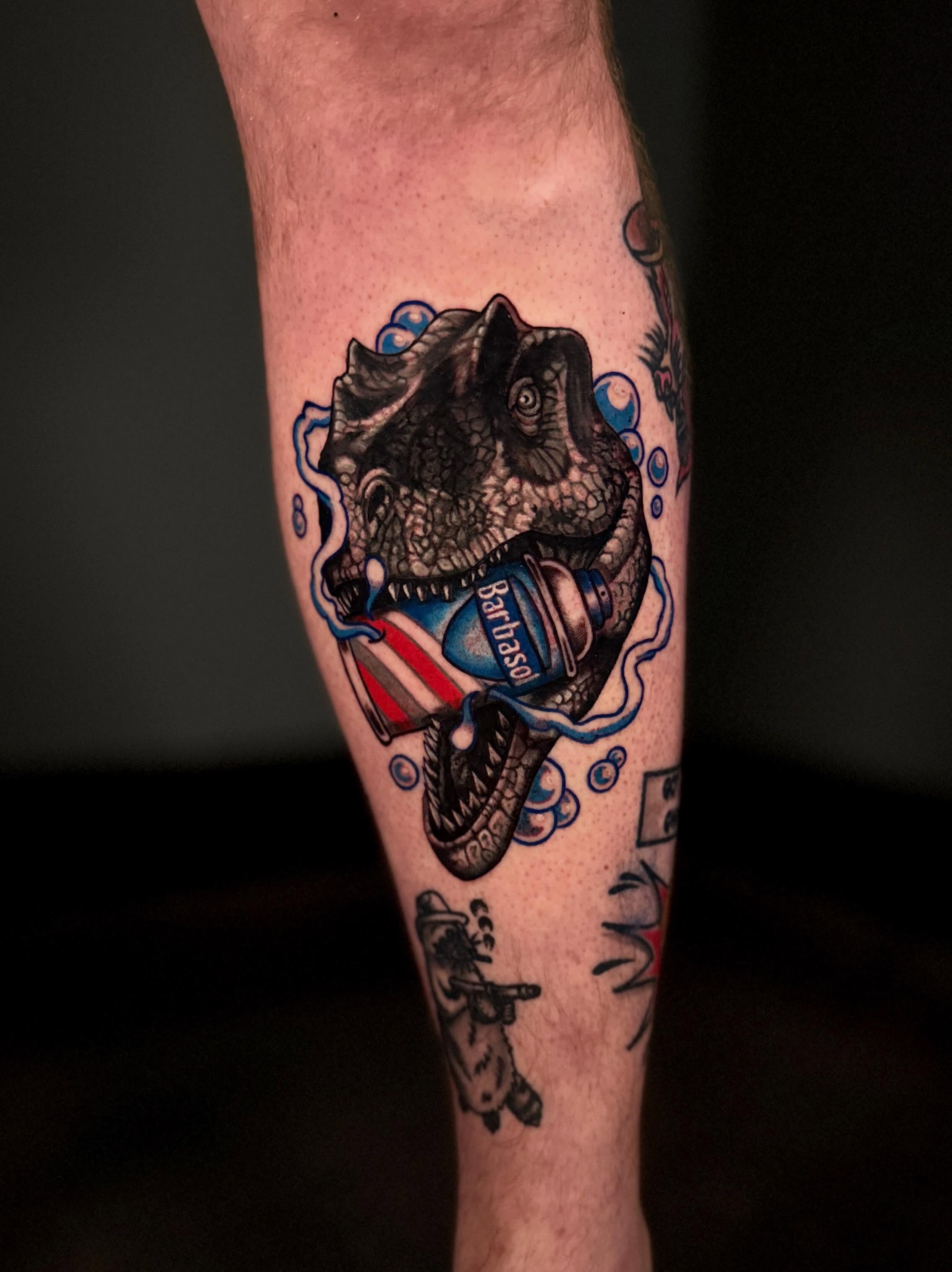 Dinosaur shaving American traditional tattoo on the forearm by Dallas Tattoo Artist