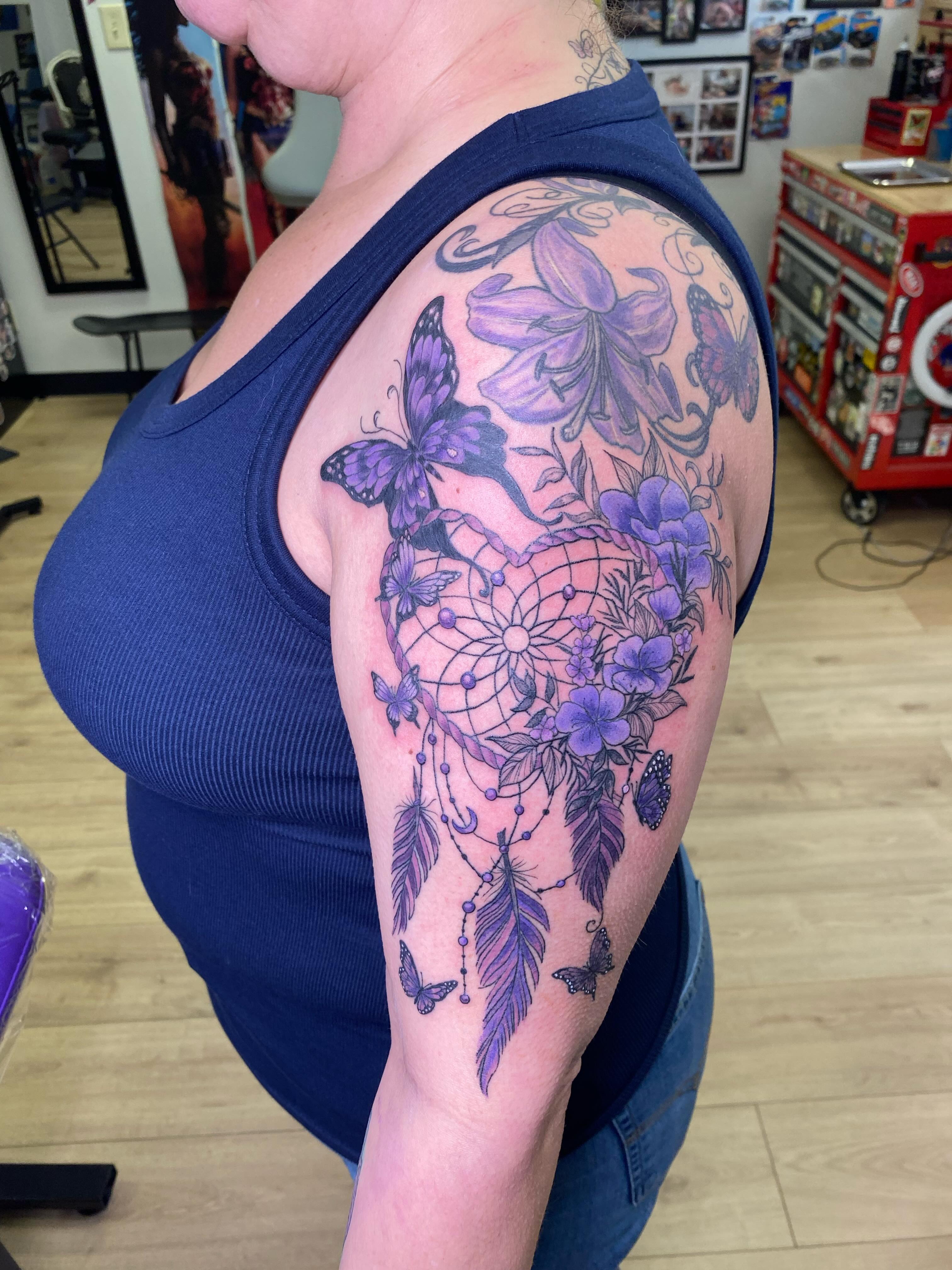 Dreamcatcher and flowers dotwork tattoo on the shoulder by Katie Leeper