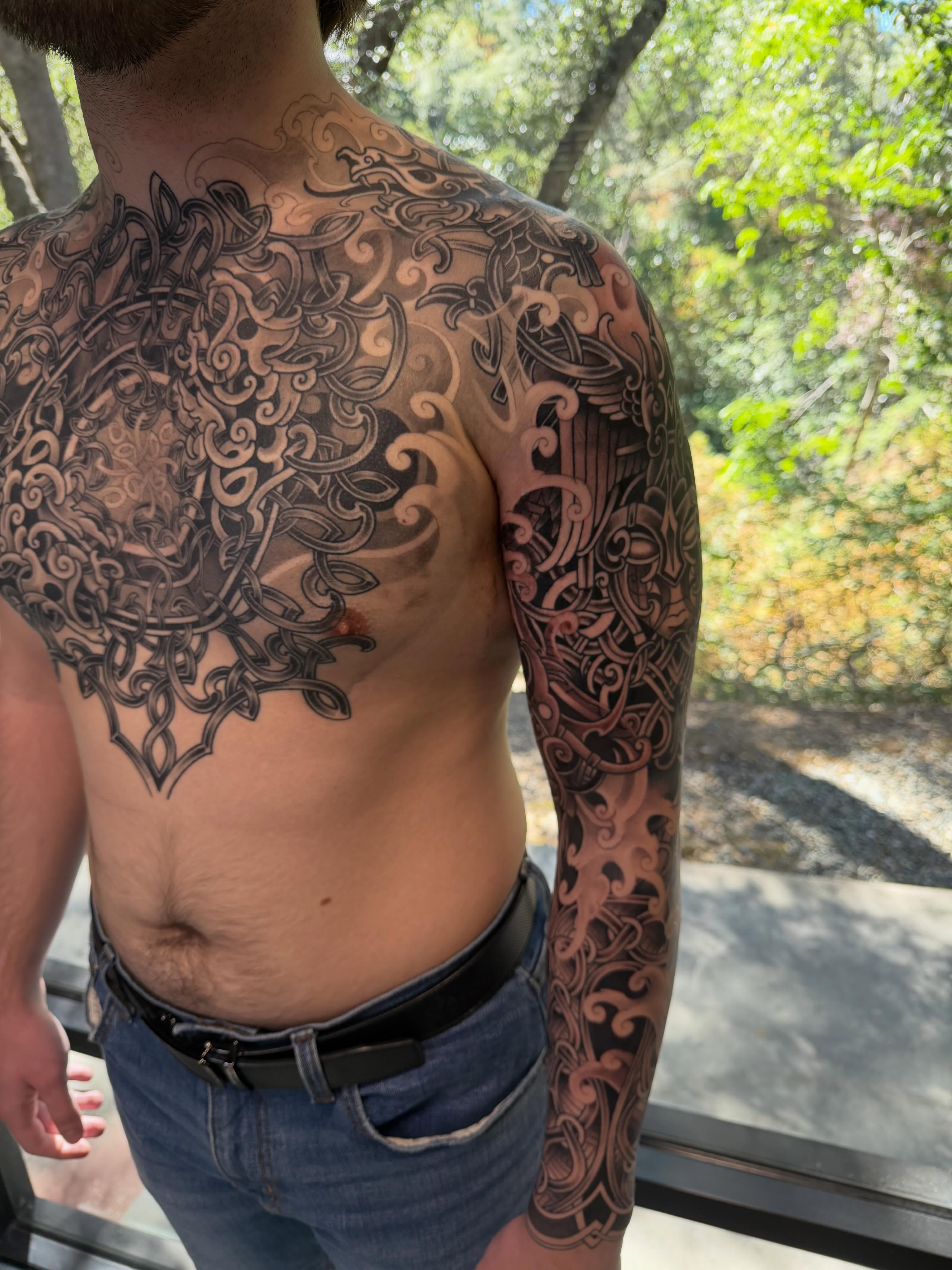 Floral mandala black and grey tattoo on the back by <