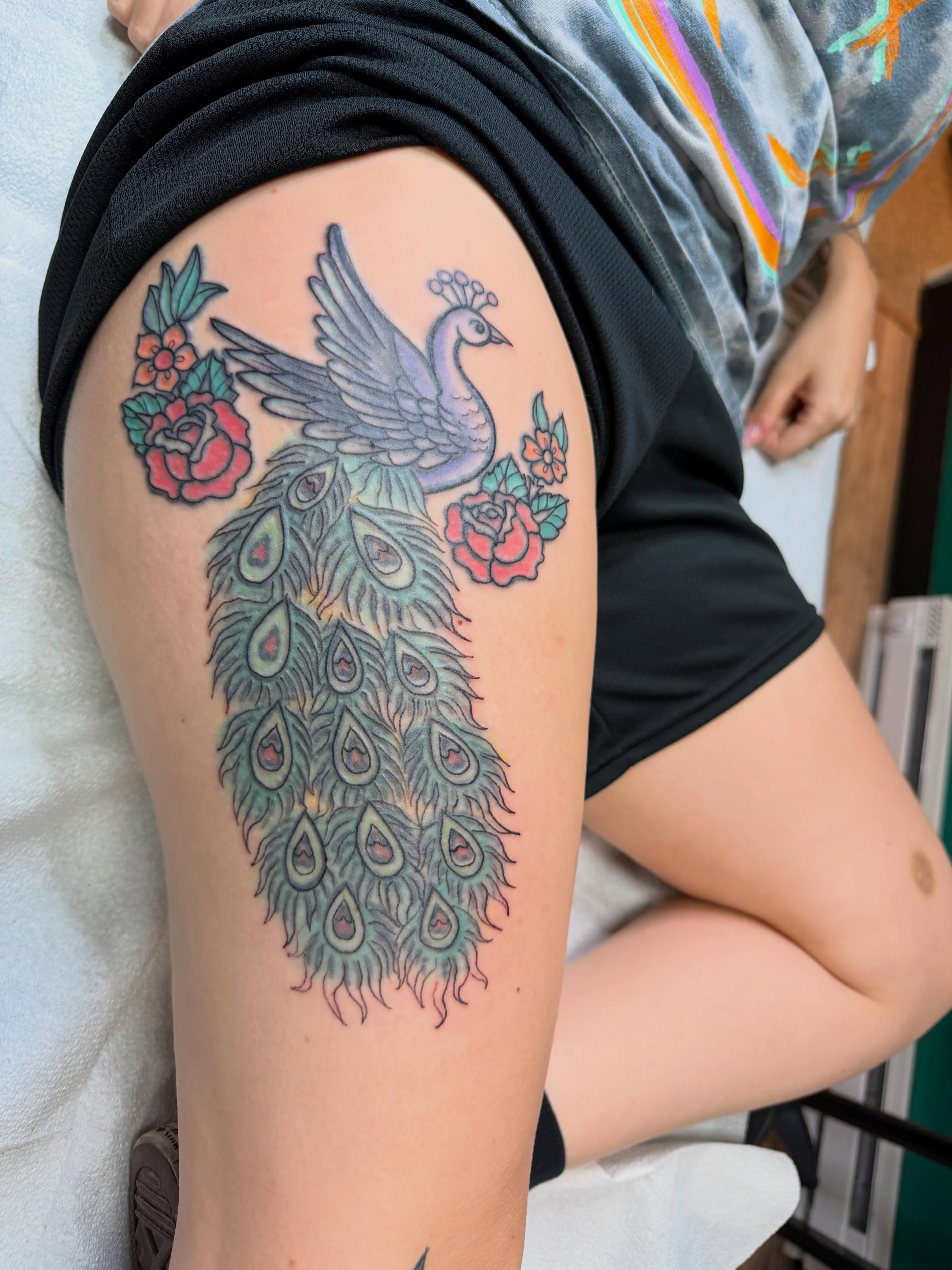 Peacock and roses American traditional tattoo on the thigh by Gabrielle Frelak, York, Pennsylvania