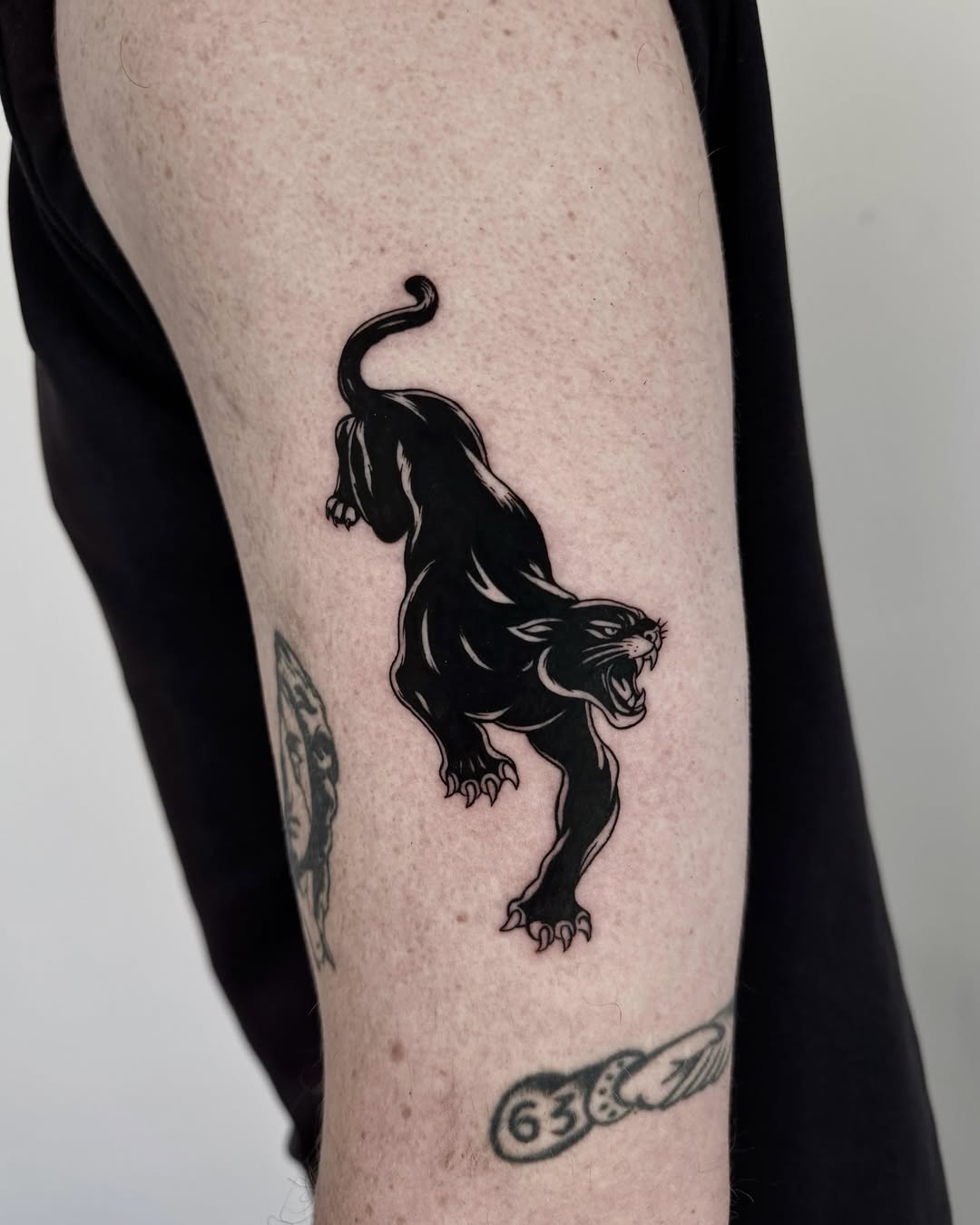 Panther black and grey tattoo on the forearm by Blackwork Vamos