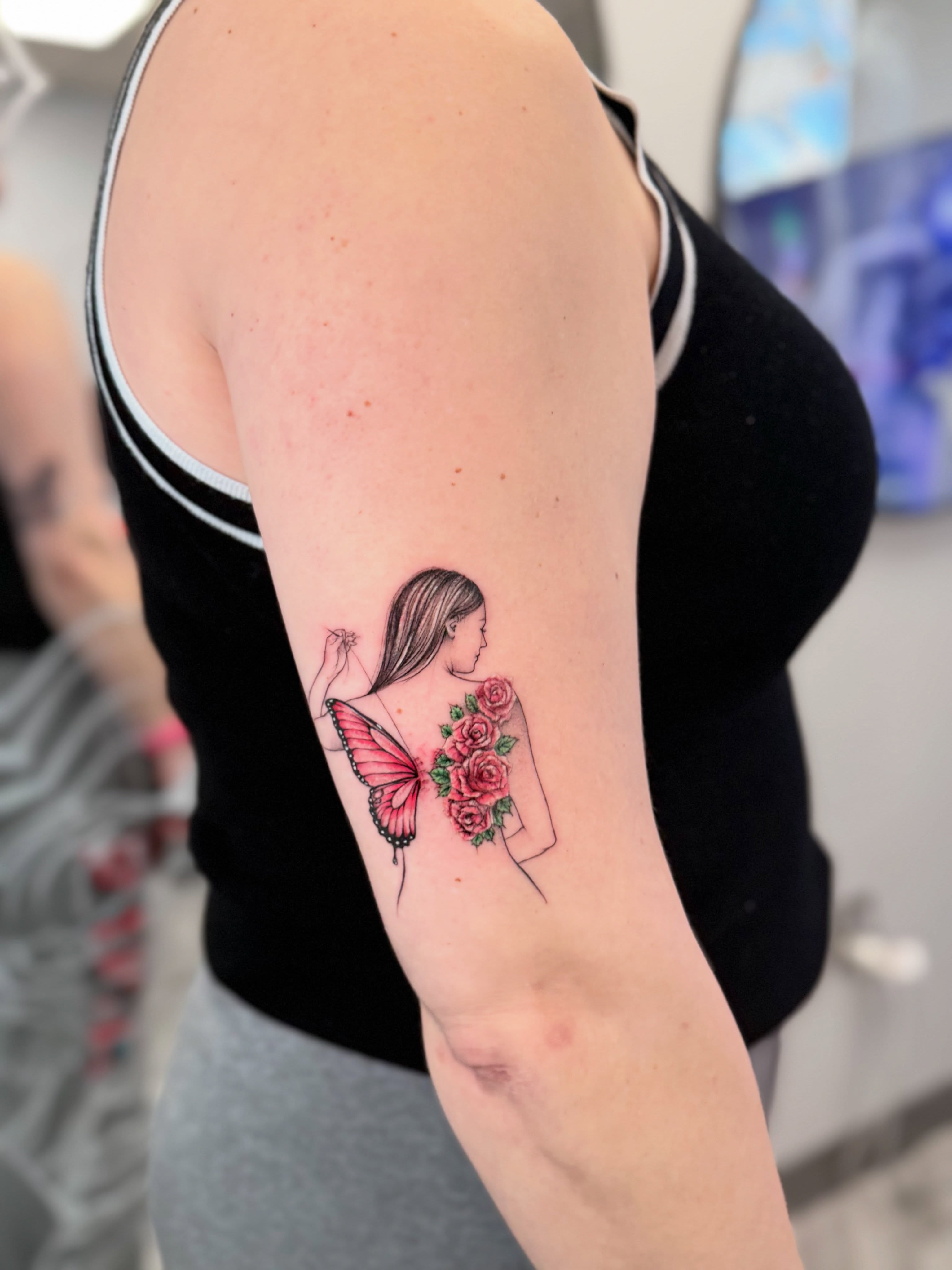 Butterfly and roses new school tattoo on the forearm by Sebastian