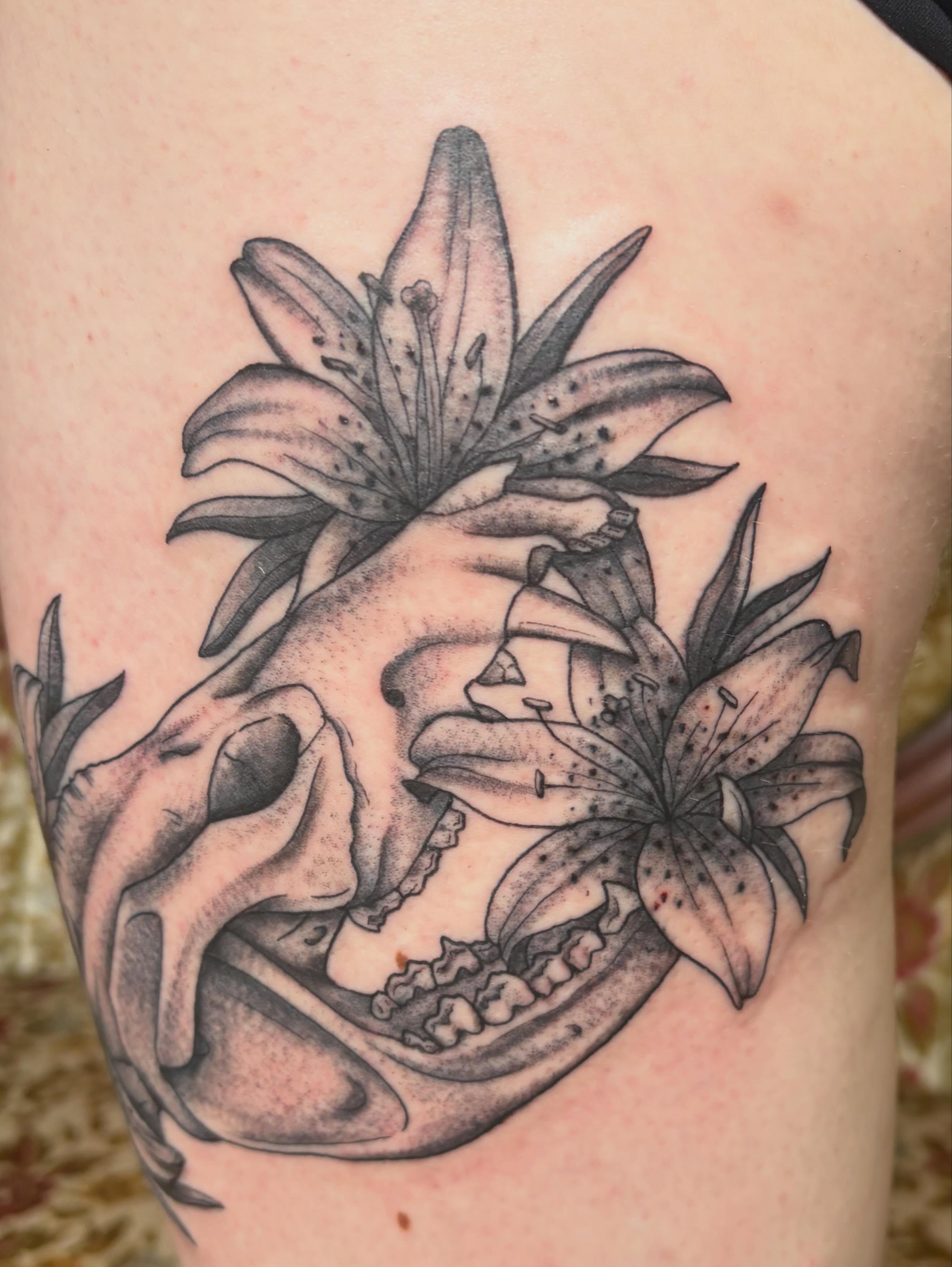 Lily skull realism tattoo on the thigh by Mary Hannah Sosdian