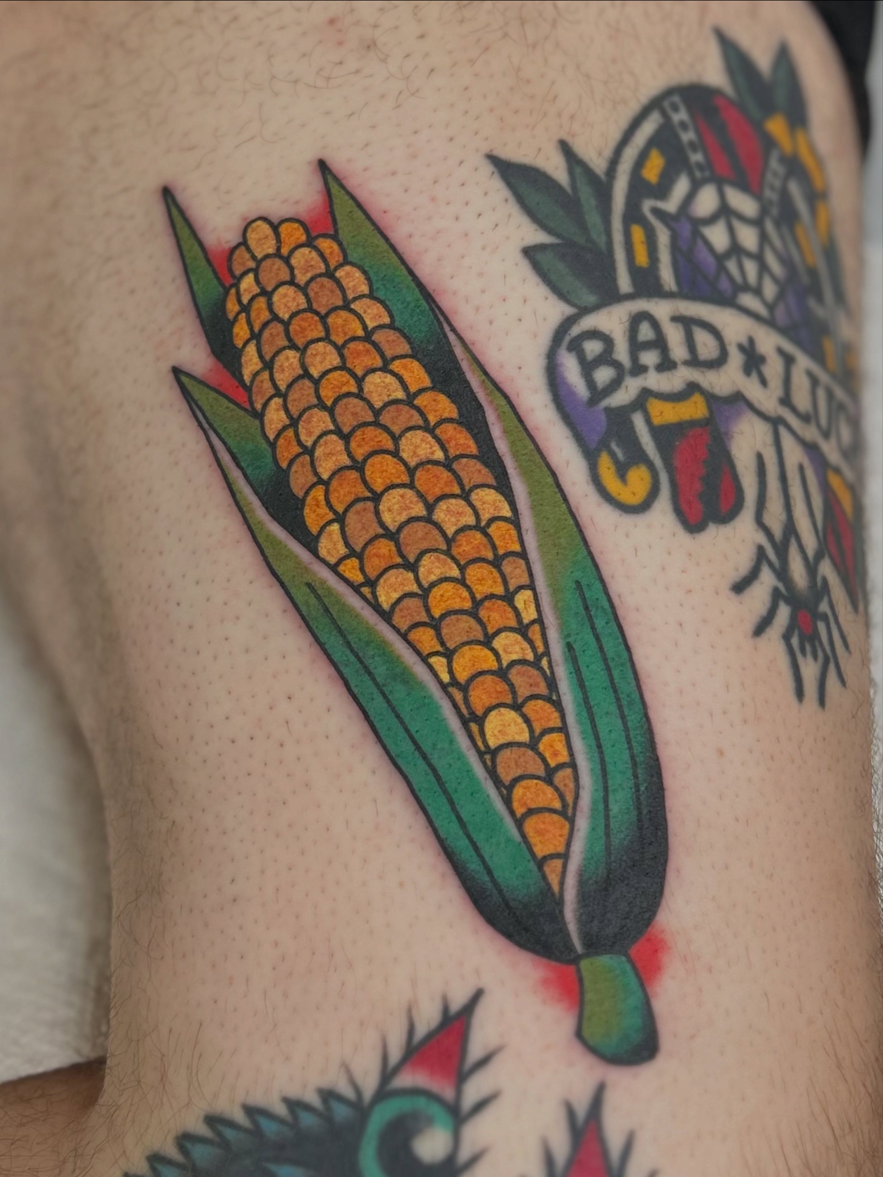 Corn ear American traditional tattoo on the thigh by Lauren Alexandra