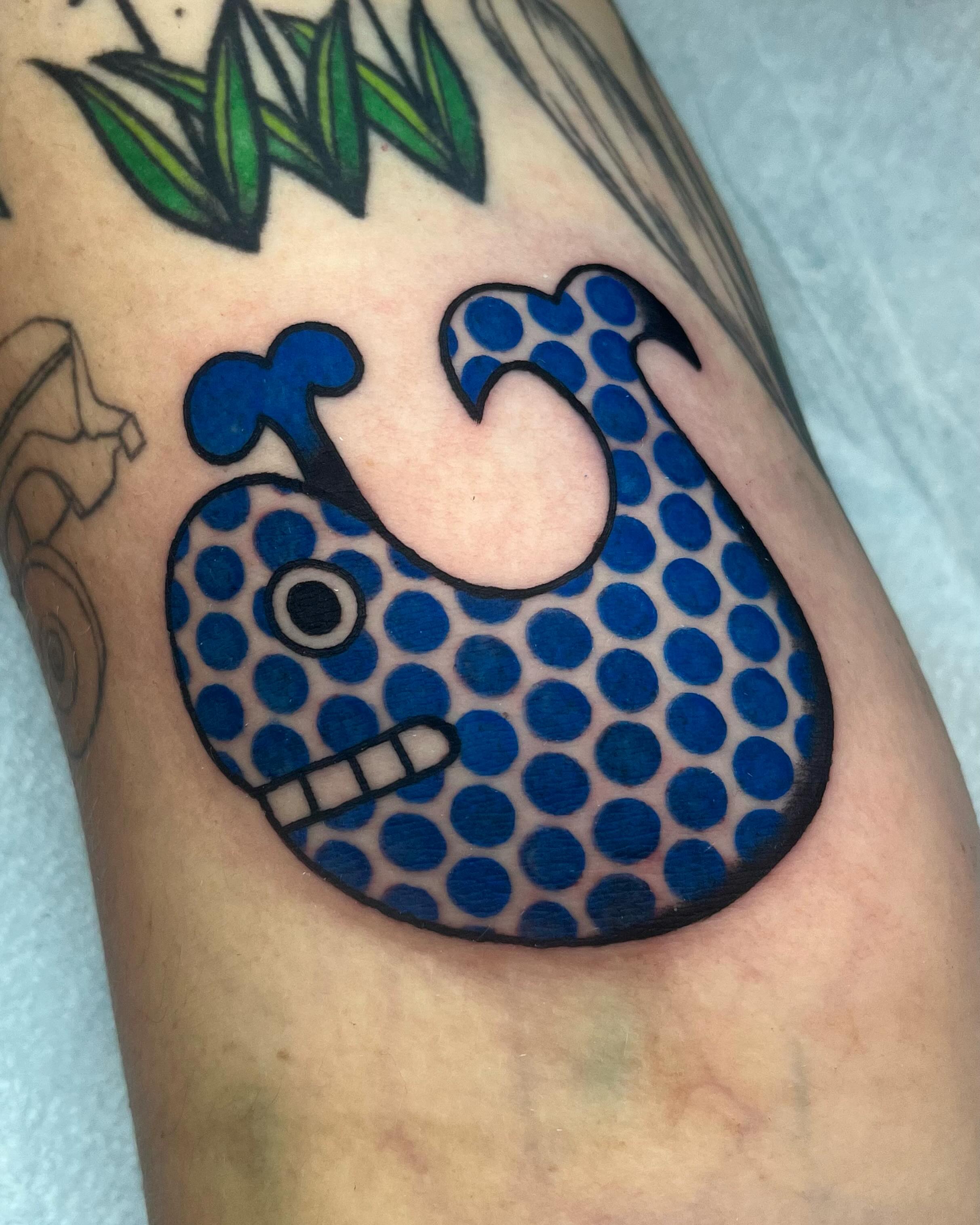 Polka dot fish dotwork tattoo on the forearm by Em Adkins