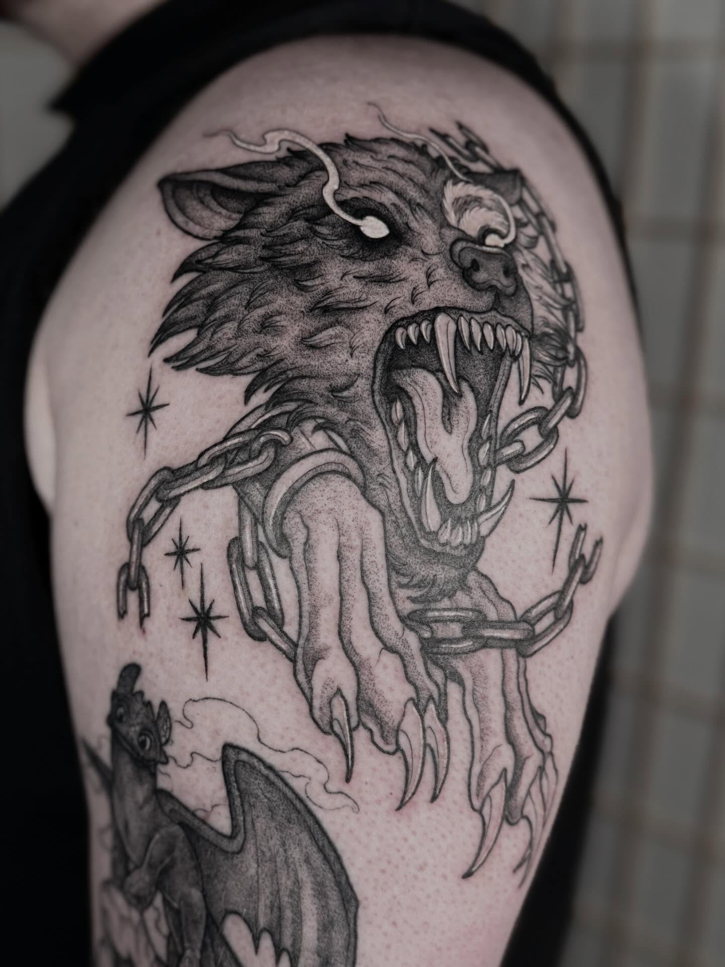 Wolf black and grey tattoo on the shoulder by Cincinnati