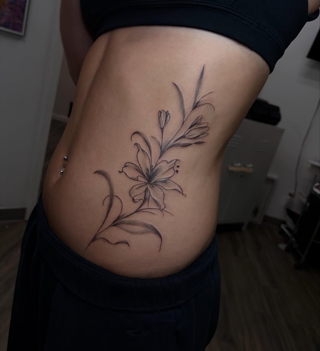 Lily black and grey tattoo on the ribs by Cincinnati Tattoo Artist