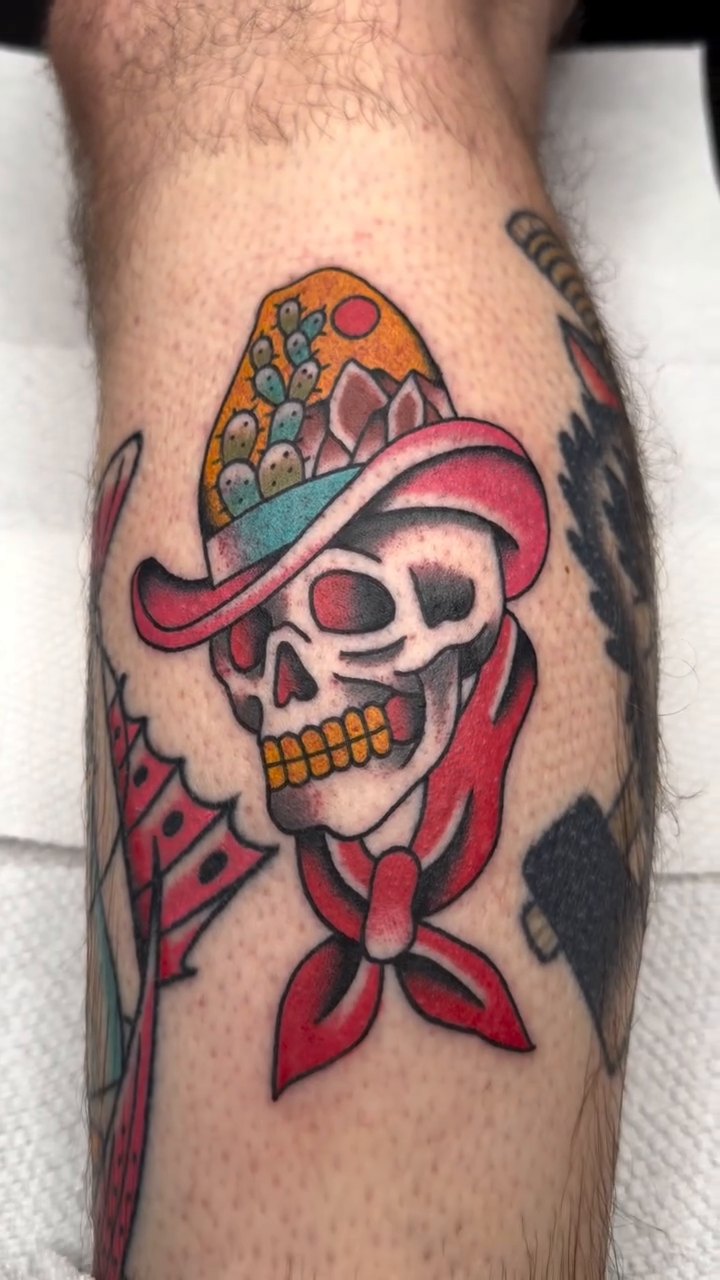 Cowboy skull with bandana American traditional tattoo on the upper arm by Jace LaFace